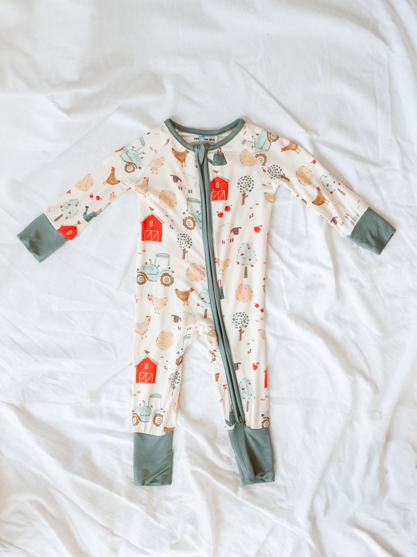 Soft bamboo pajama sleeper with farm day theme with chickens, tractor, barn, sheep, apple trees and apples.