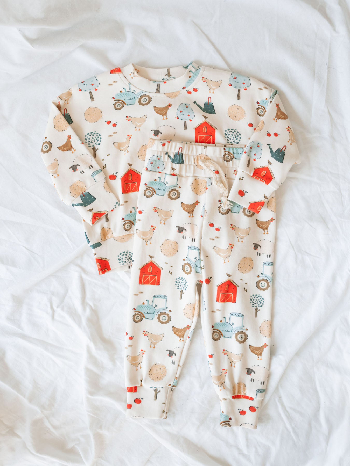 lounge set for babies and toddlers with farm days print. Laying on white linen background