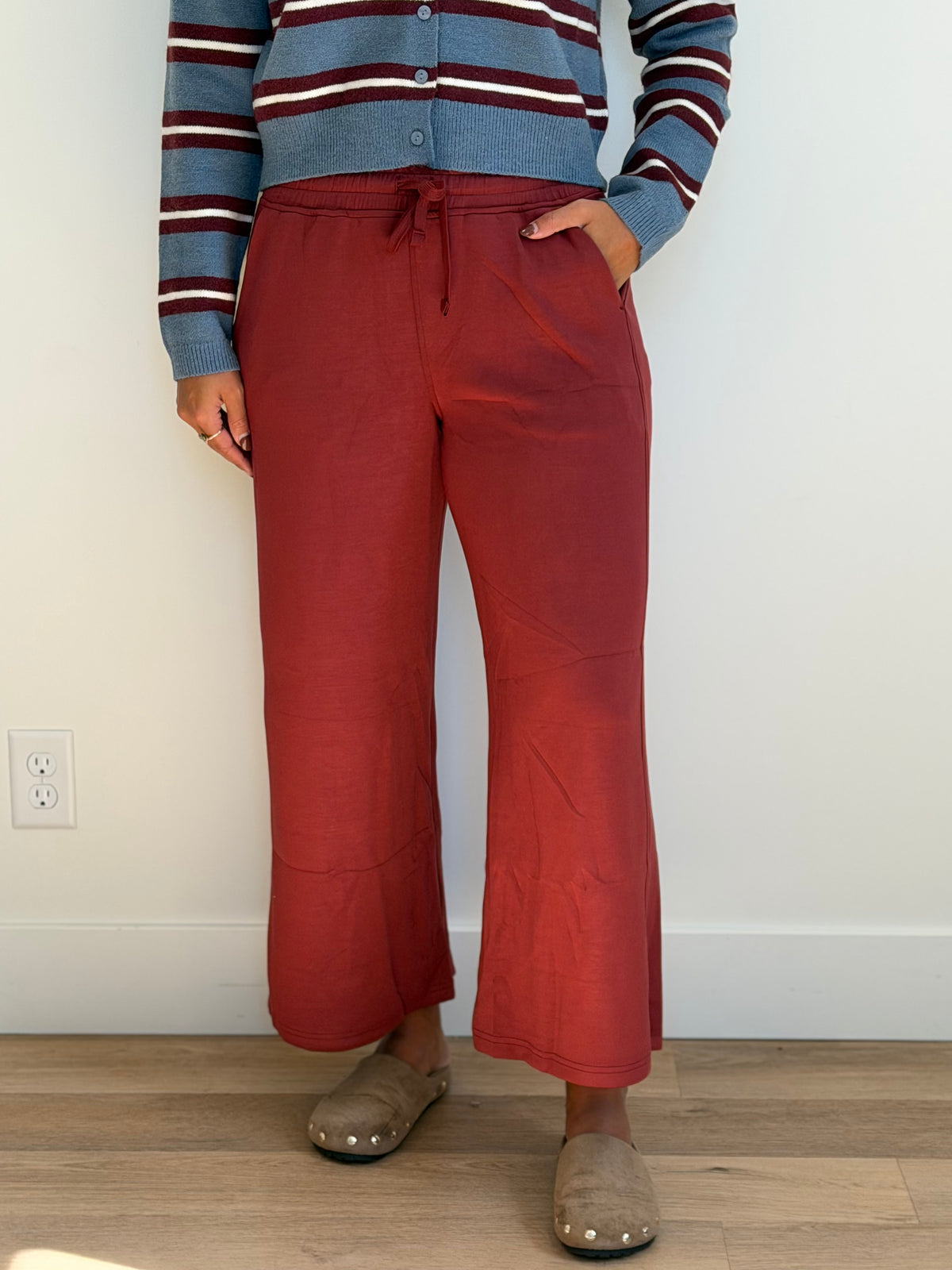 Model is wearing the butter soft drawstring waist cropped pants in merlot.