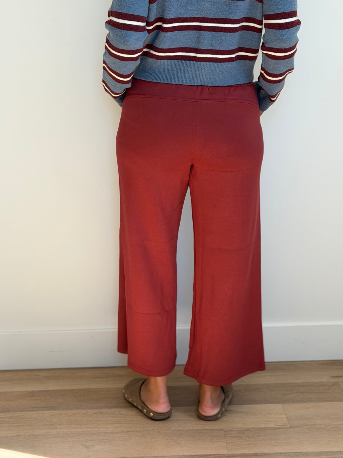 Model is wearing the butter soft drawstring waist cropped pants in merlot.