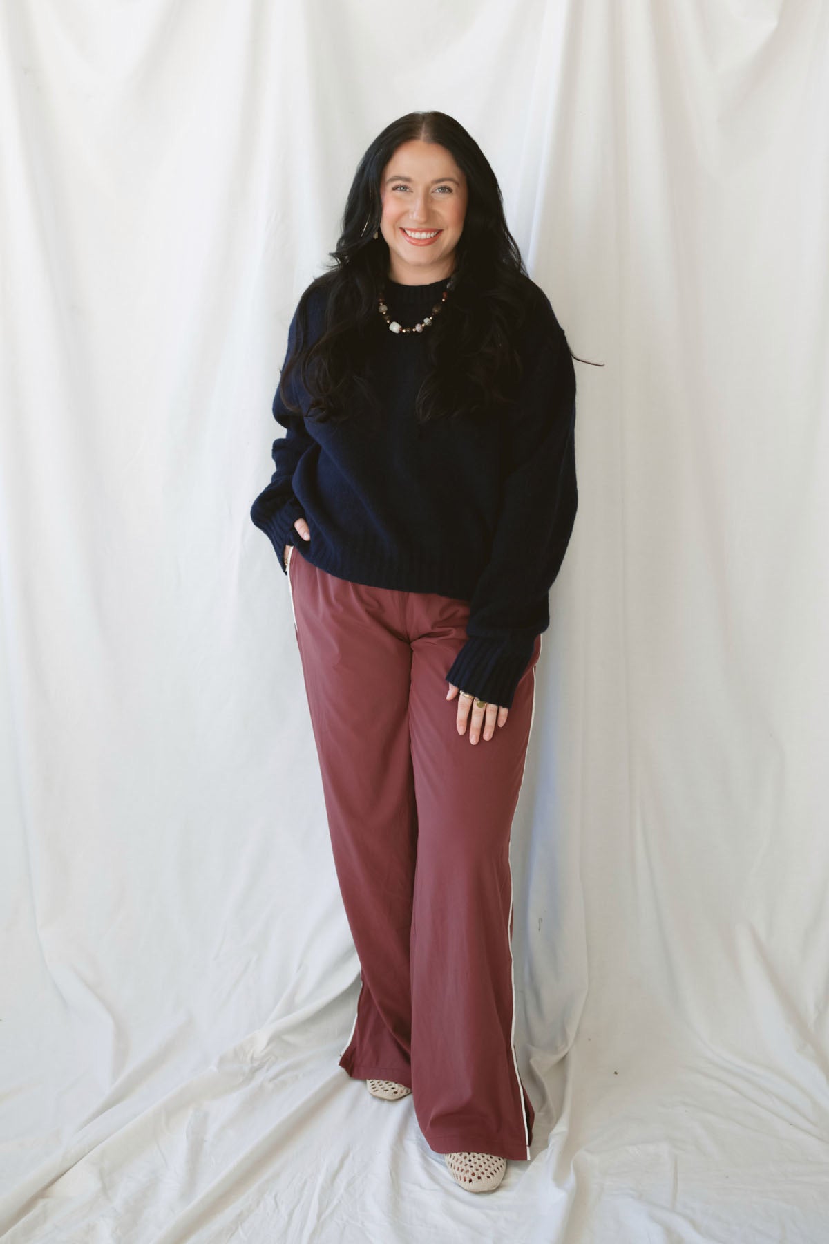 Jordan Finish Line women's track pants in Rosewood, featuring a muted earthy pink color and sporty casual silhouette for relaxed everyday outfits.