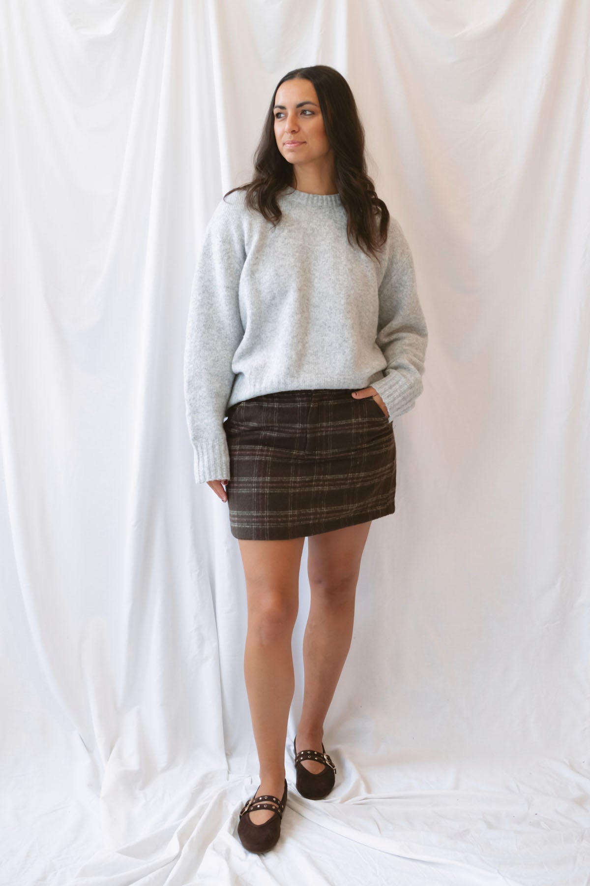 Kendra Brushed Plaid Mini Skirt in chocolate brown and olive featuring a classic plaid pattern and soft brushed texture.
