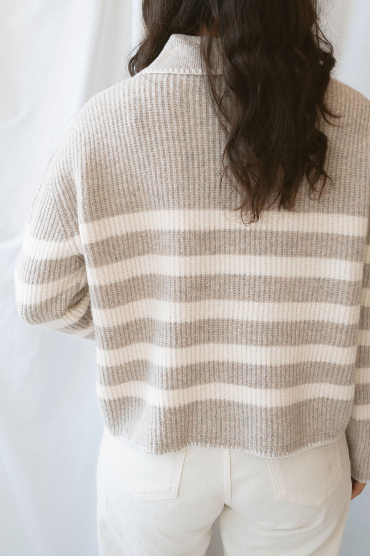 Carly light taupe striped knit sweater with a collared V-neckline and contrast trim.