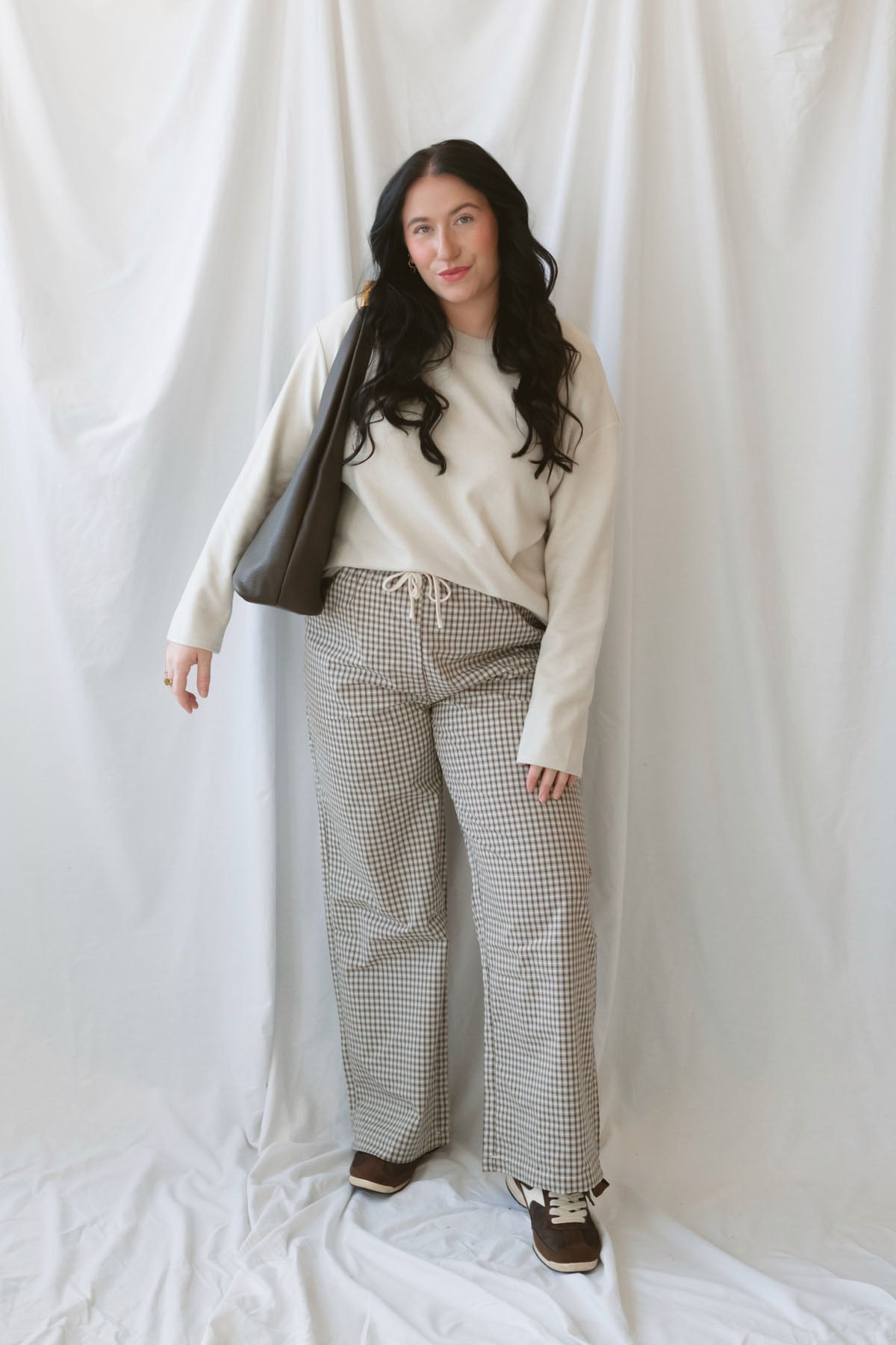Avery brown and off-white checkered loose fit pants with an adjustable tie-front waist.