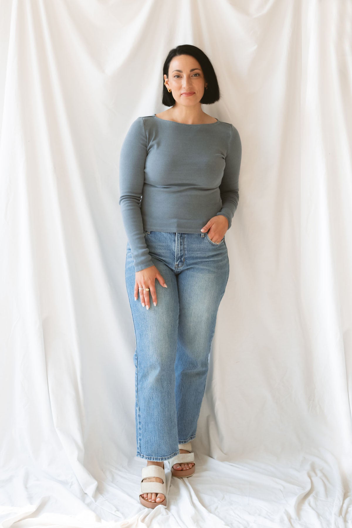 Model wearing ribbed long sleeve boat neck top. Paired with a basic denim pant, but can be styled in a variety of ways.