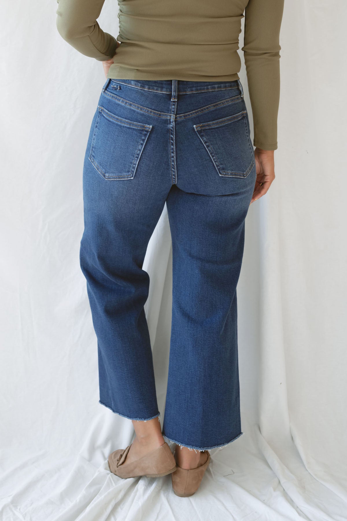 Model wearing the scissor cut slim denim in a dark wash. Great length to wear with a pointed toe boot or sneaker. Can easily be dressed up or down.