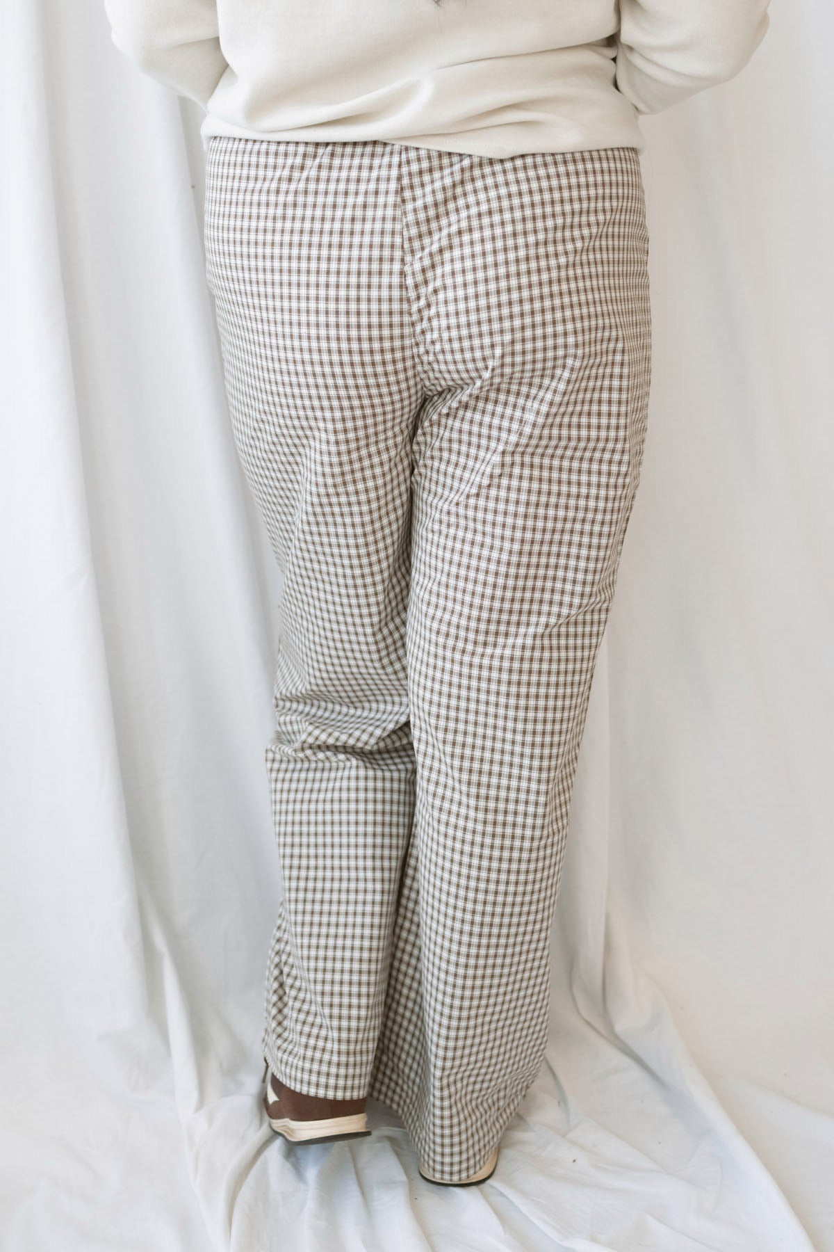 Avery brown and off-white checkered loose fit pants with an adjustable tie-front waist.