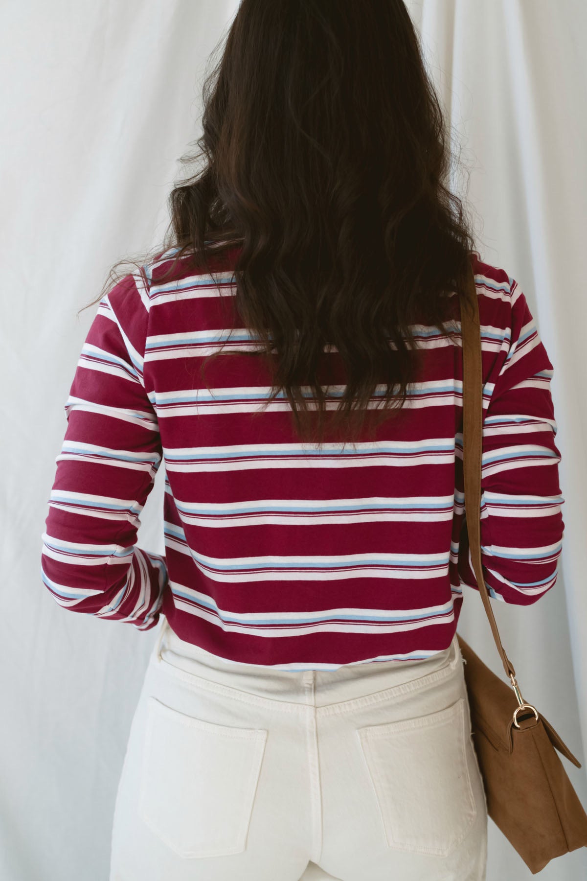 Model is wearing striped long sleeve round neck t-shirt