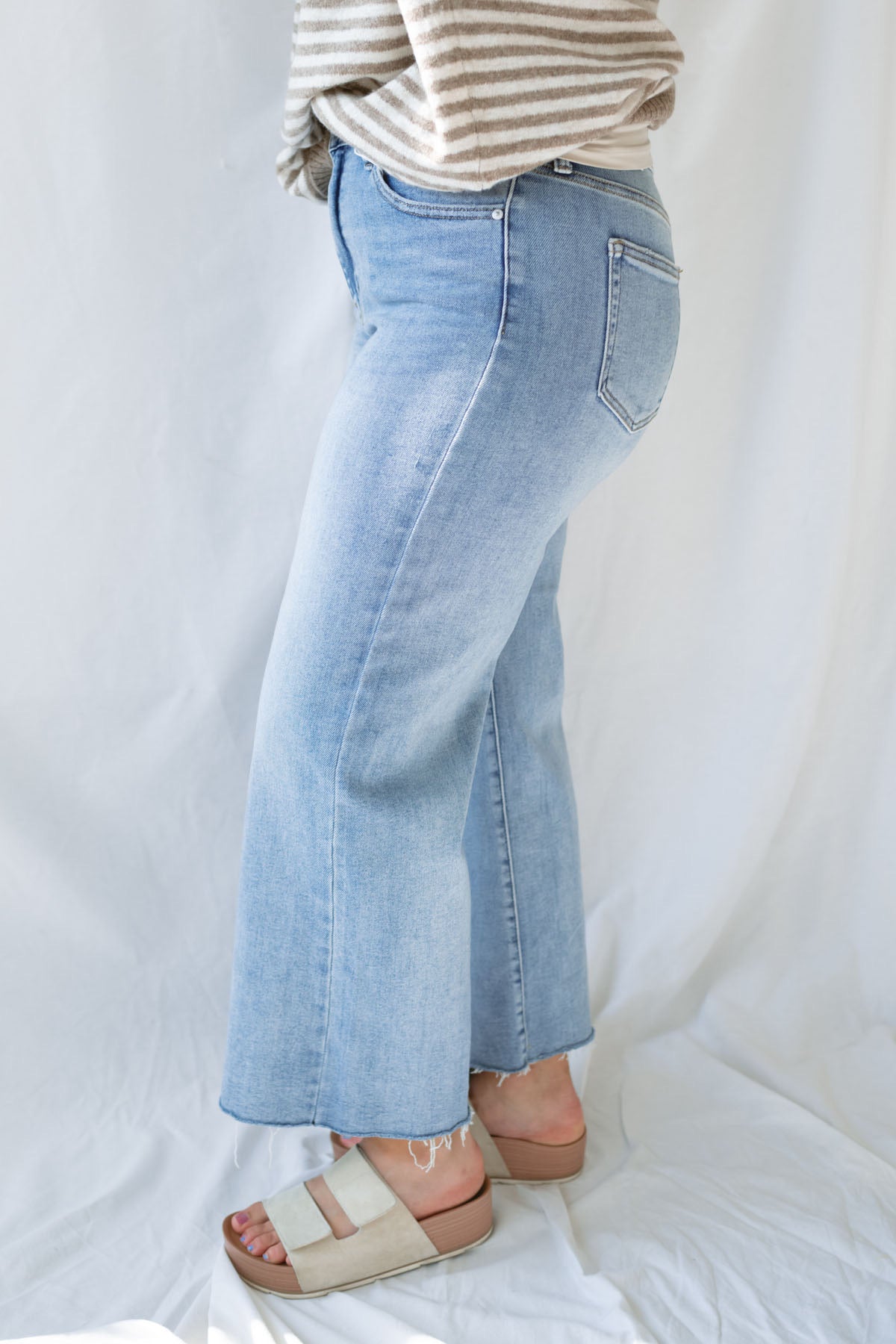 Side view of model wearing the Piper medium wash denim.