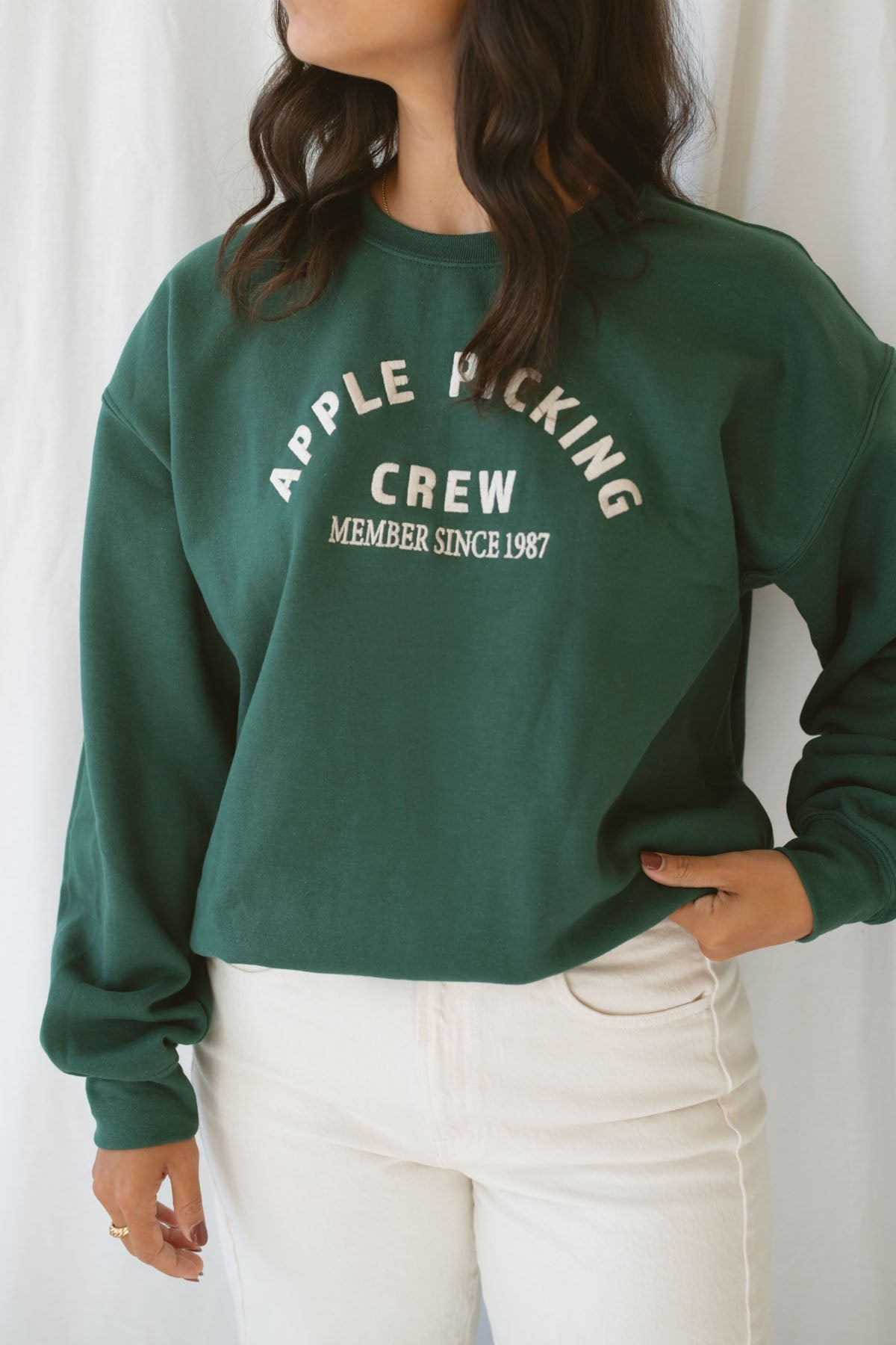 Model is wearing the apple picking sweatshirt in green.