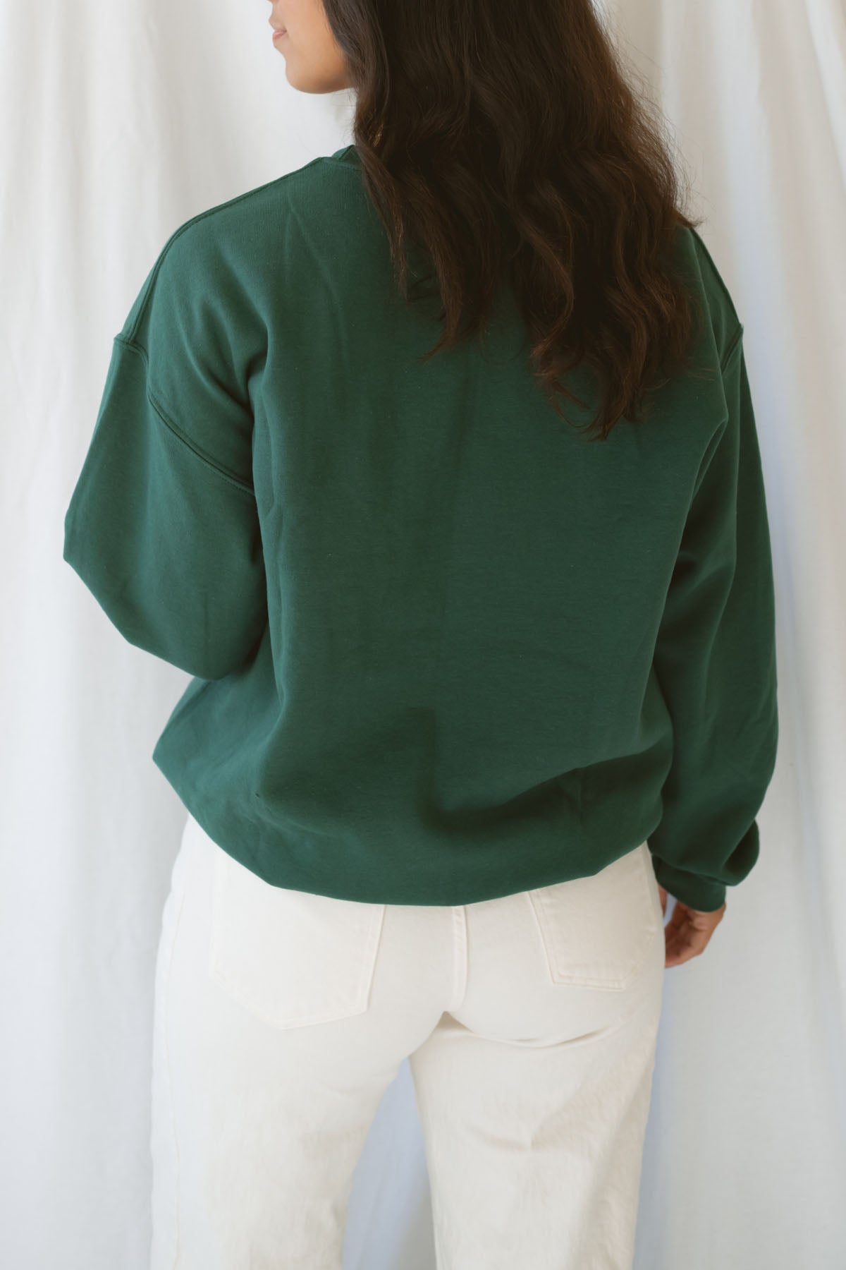 Model is wearing the apple picking sweatshirt in green.