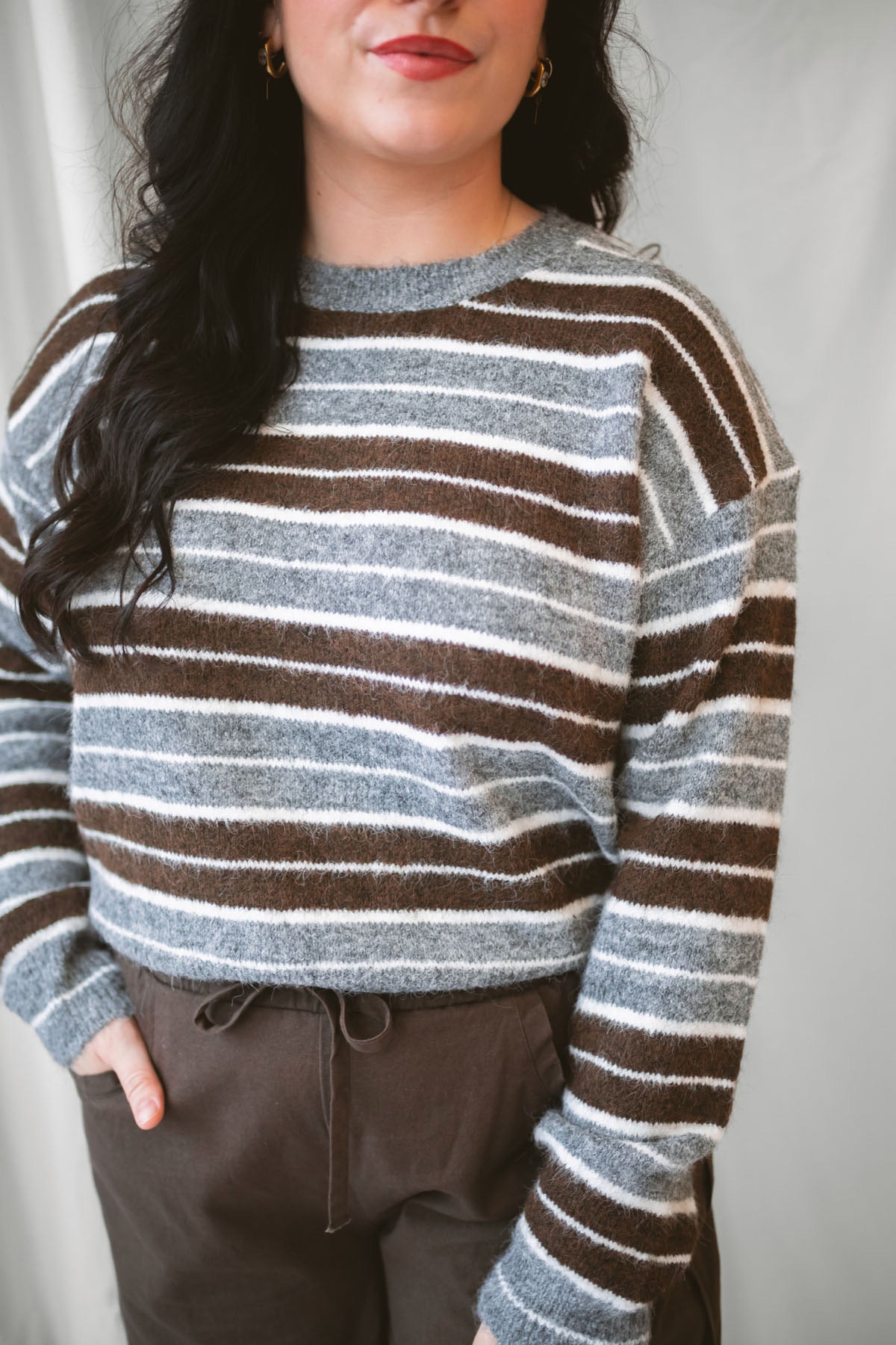 Abbie Striped Crew Neckline Long Sleeve Cropped Knit Sweater in Brown Multi with a warm neutral stripe pattern.
