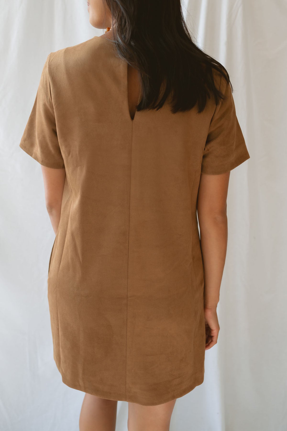 Model wearing the faux suede mini t-shirt style dress. A casual option that can be dressed up with boots and jewelry.