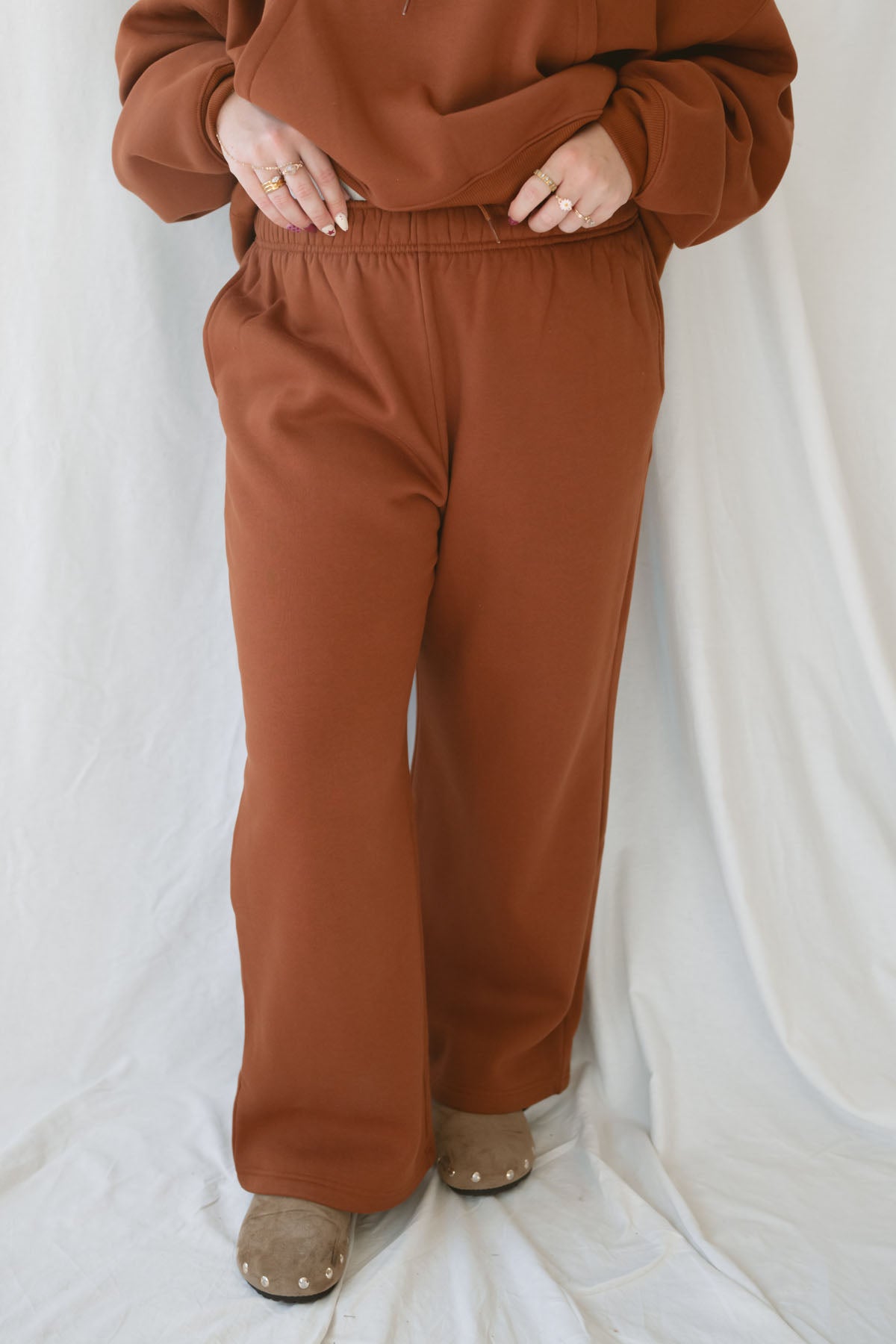 Model wearing the fleece straight leg sweatpants with elastic waistband.