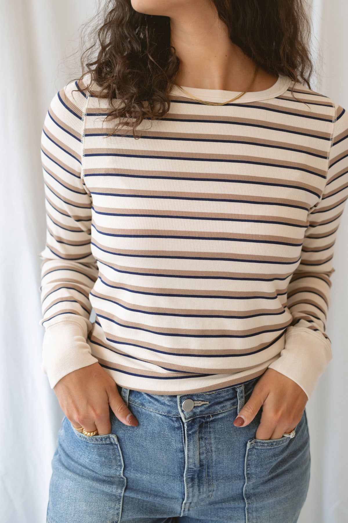 Model wearing the cream stripe long sleeve top.