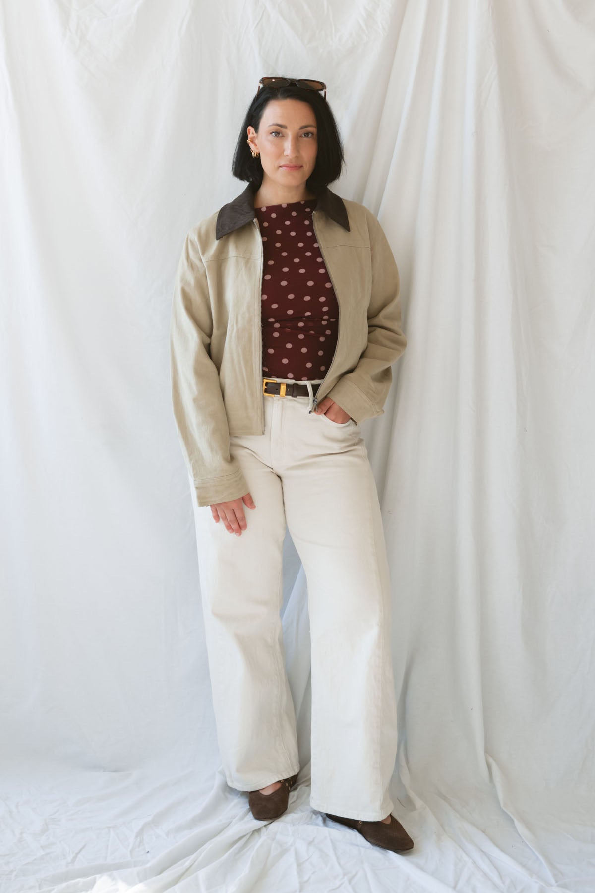 Model wearing the contrast corduroy collar zip up bomber jacket over the rynlee polka dot mesh tank in burgundy. The jacket is a great lightweight layer for cooler months.