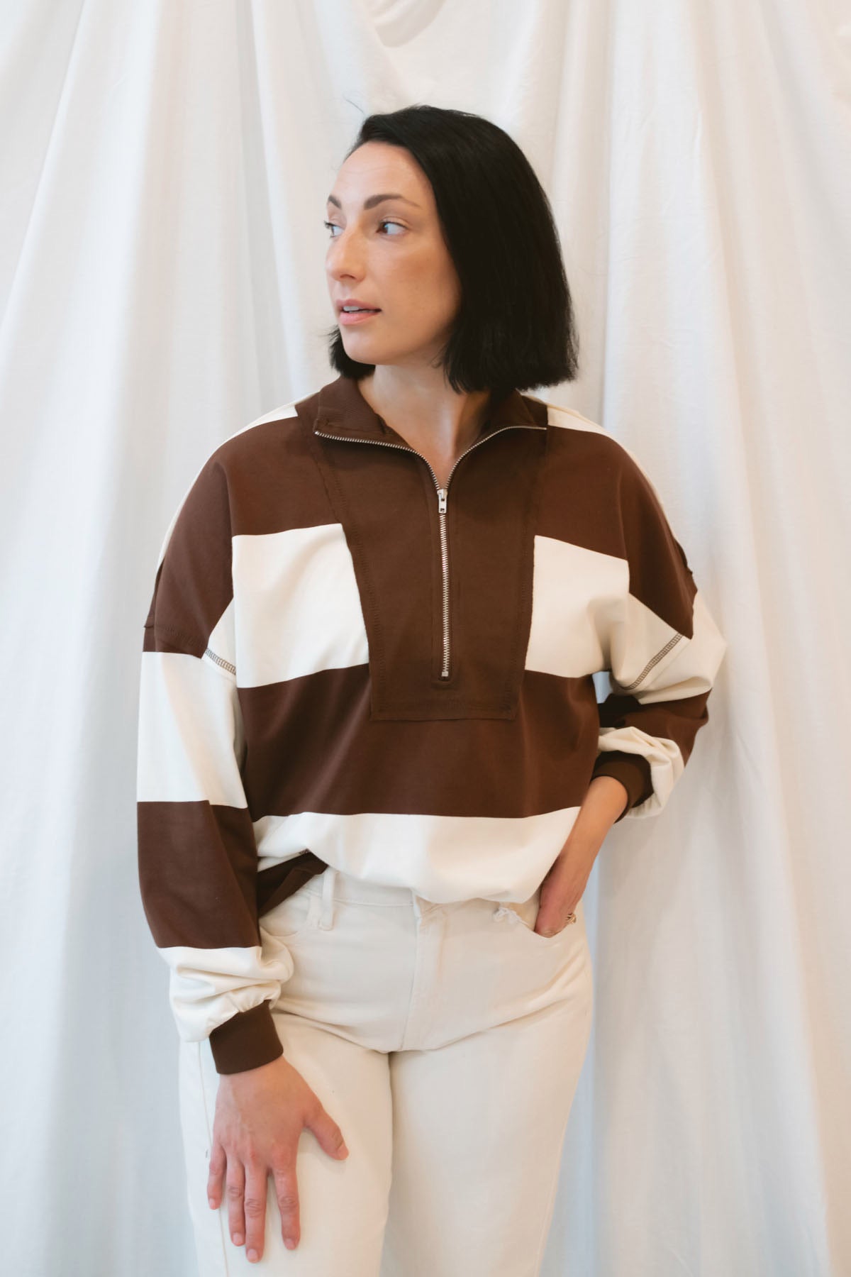 Model wearing half zip pullover sweatshirt.