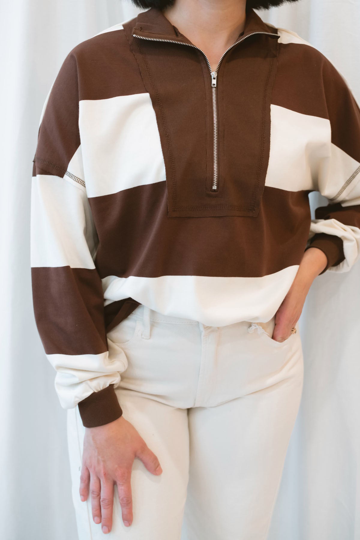 Model wearing half zip pullover sweatshirt.