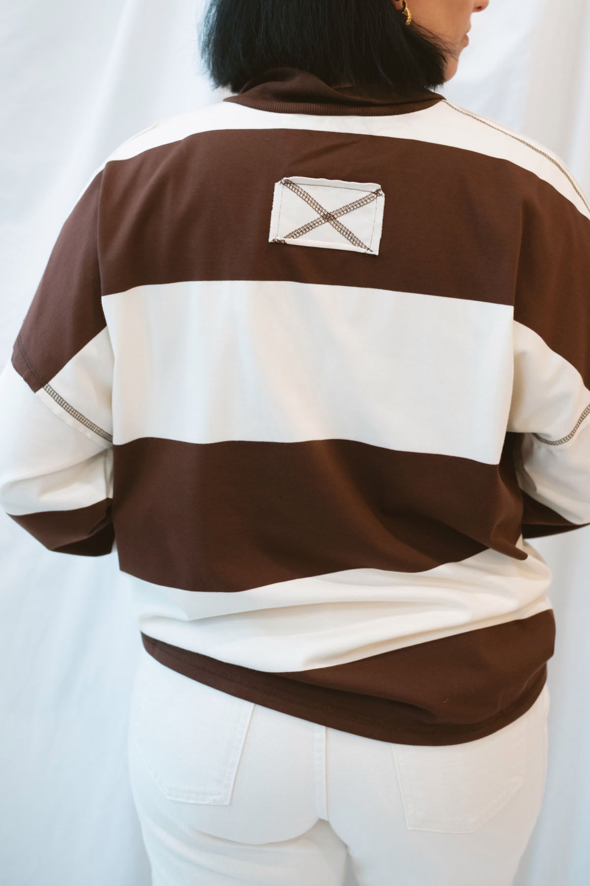 Model wearing half zip pullover sweatshirt.