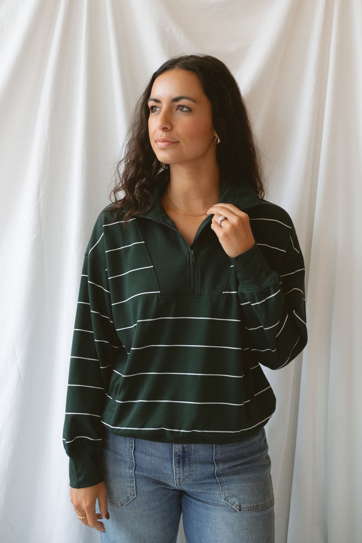 Model is wearing the butter soft stripe quarter zip sweatshirt in green.