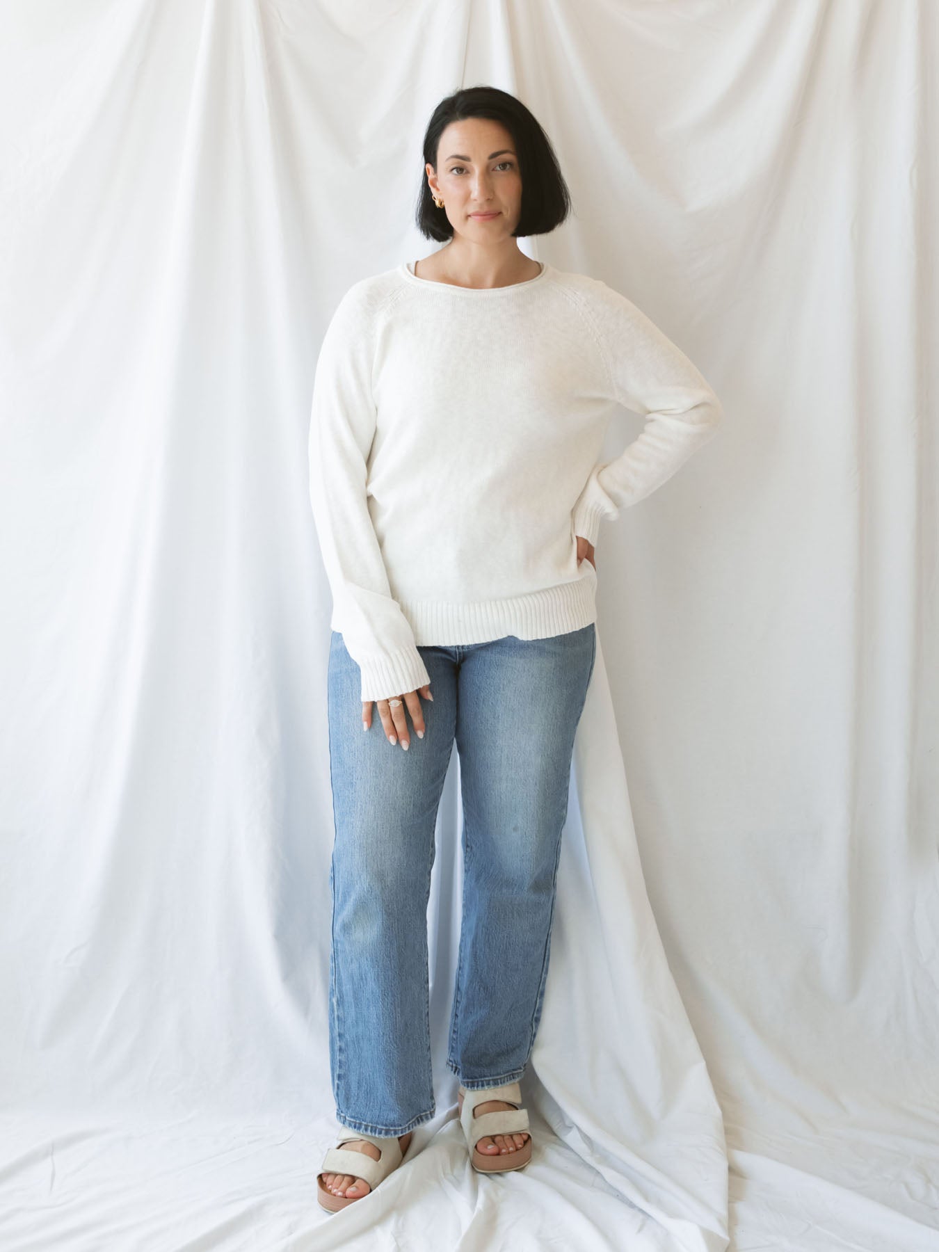 Model wearing slub pullover sweater in off white.