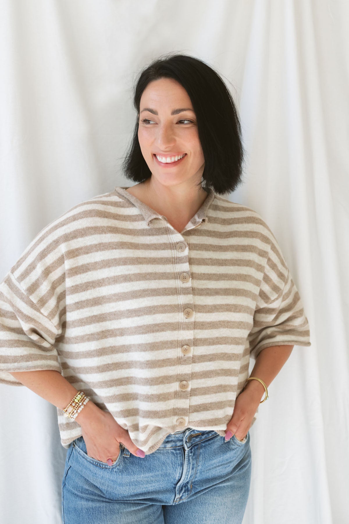 Model wearing stripe raw edge short sleeve button down.