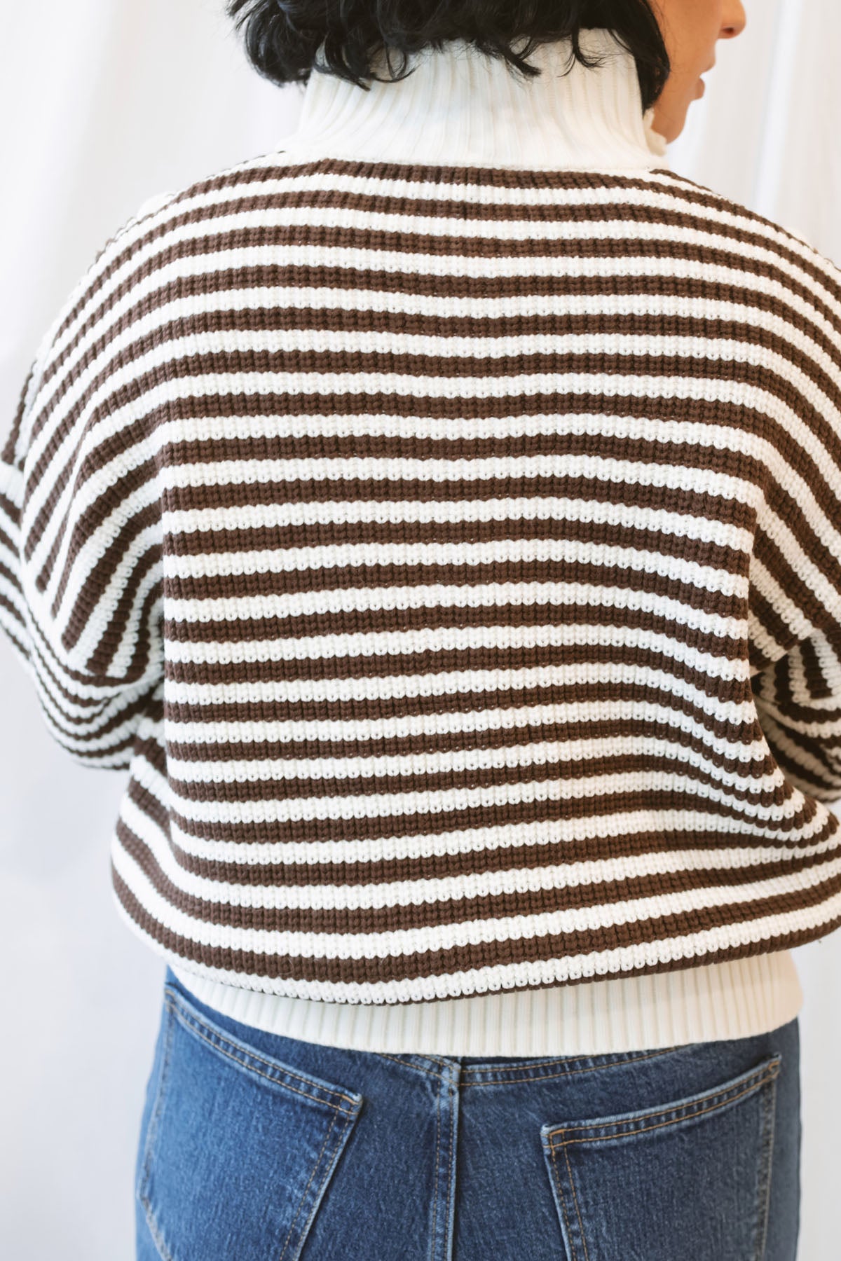 Brown striped half-zip sweater for women featuring a preppy-inspired design, classic stripe pattern, and comfortable knit silhouette for fall and winter outfits.