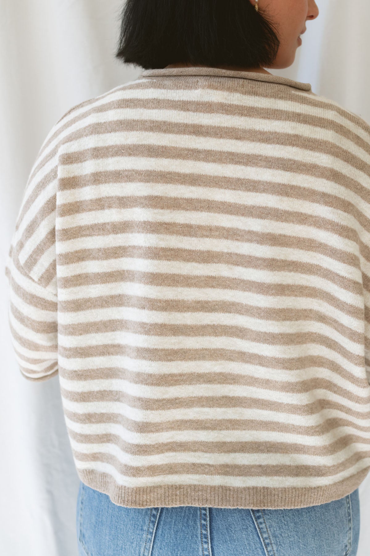 Model wearing stripe raw edge short sleeve button down.