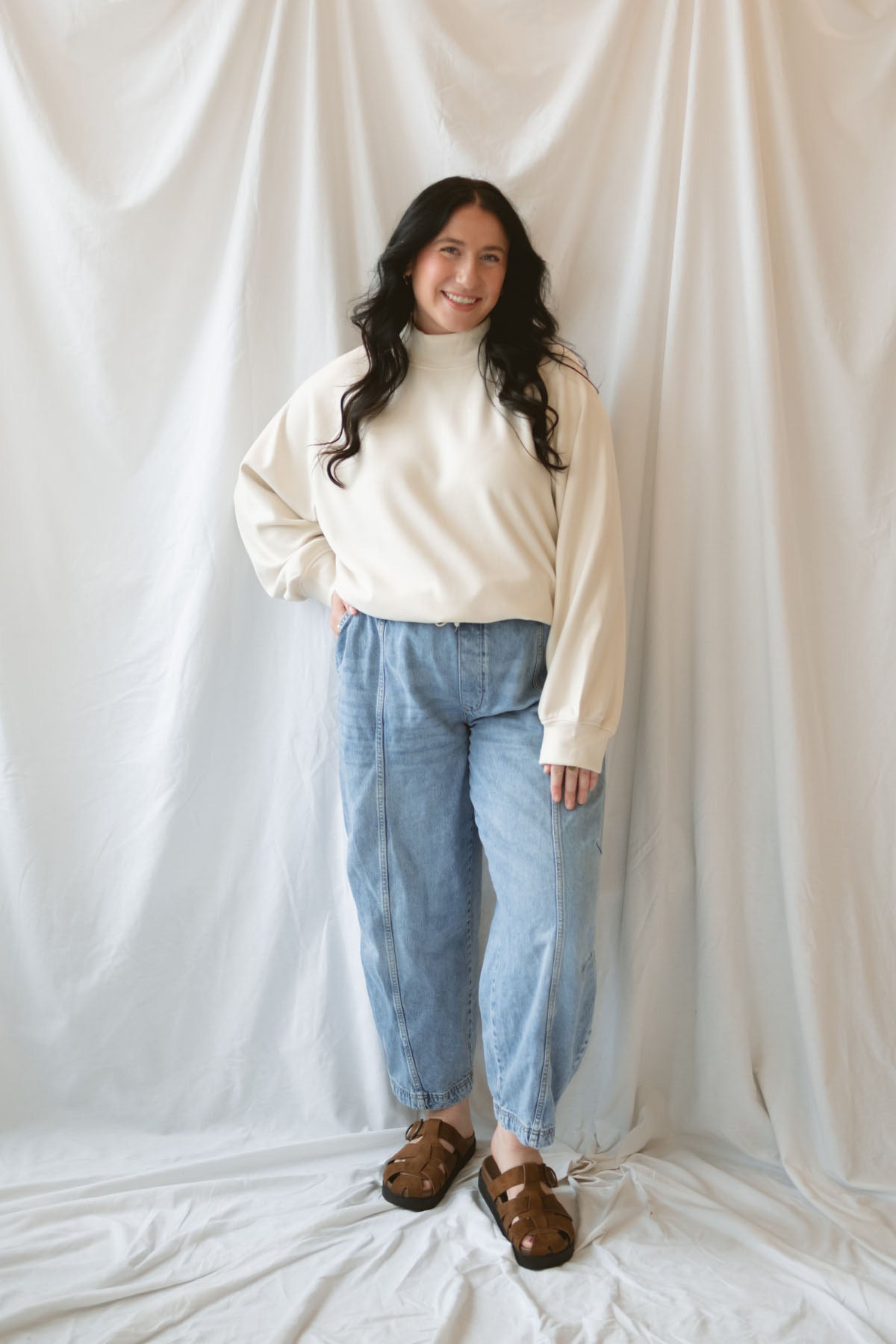 Model wearing the double brushed mock neck pullover.