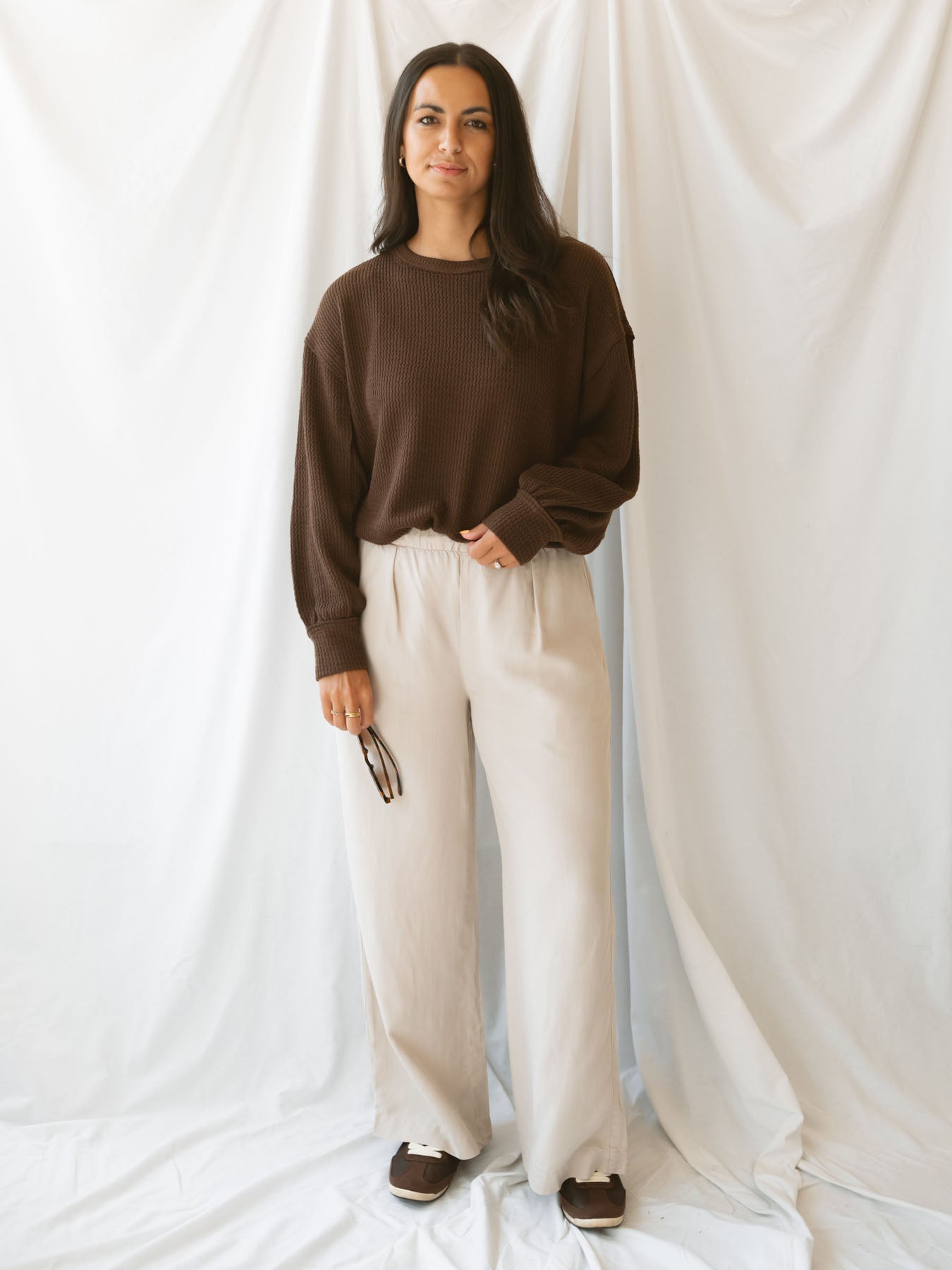 Model wearing wide leg trousers with drawstring waistband
