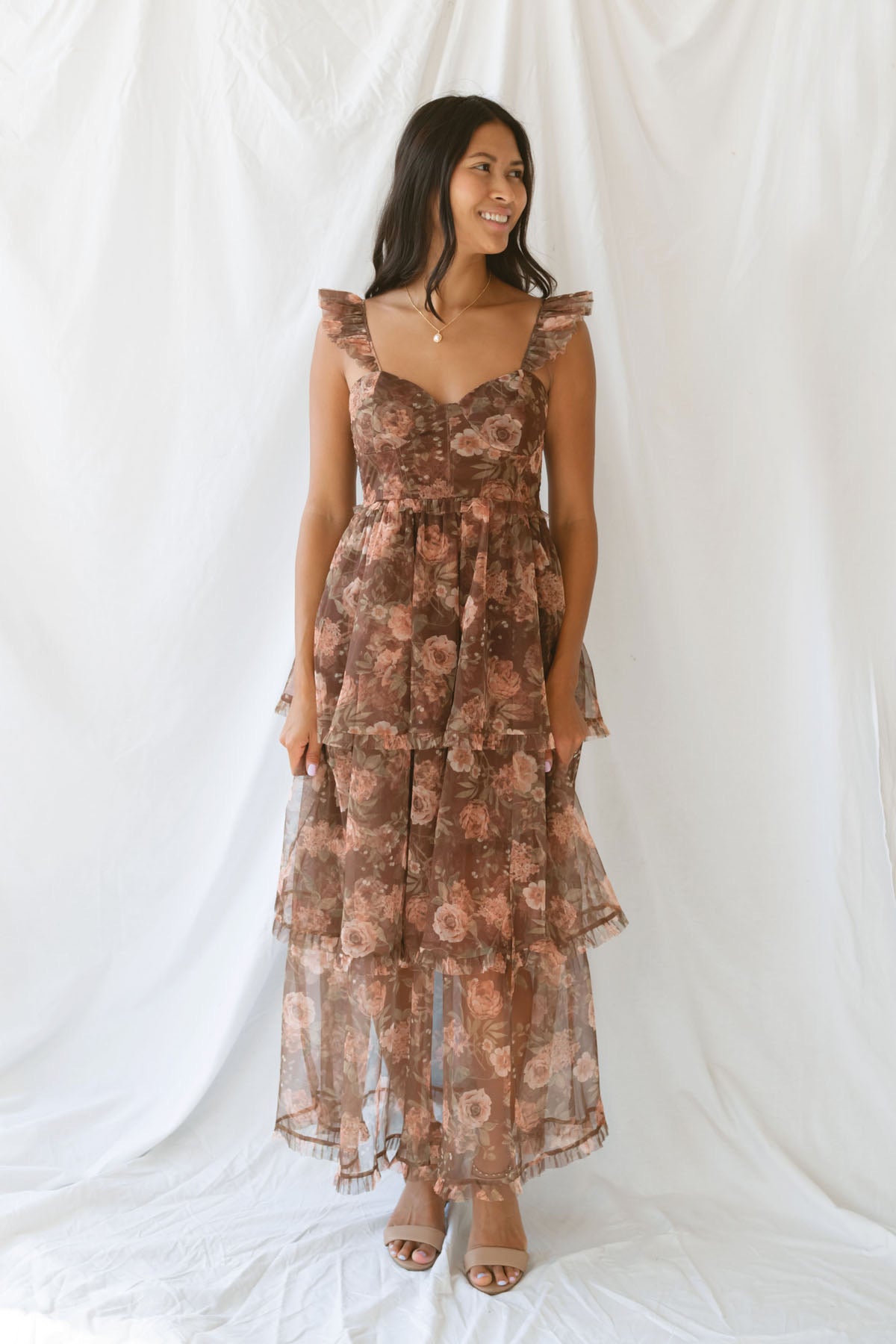 Model wearing the Floral Ruffle Dress in brown. A great fall wedding or event option.