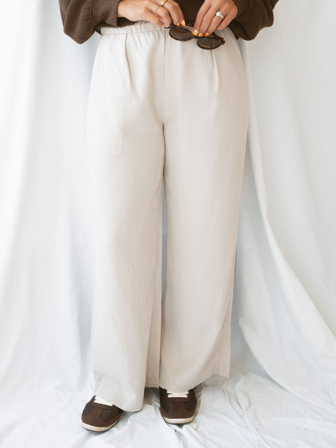 Model wearing wide leg trousers with drawstring waistband