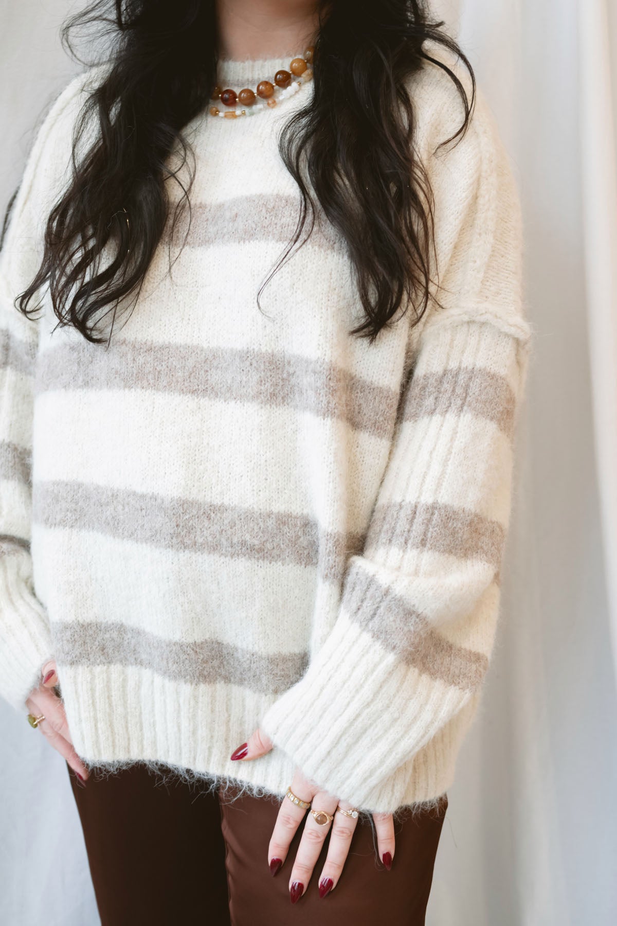 Cream fuzzy knit sweater for women featuring a classic striped pattern, relaxed boyfriend fit, and cozy textured finish for casual fall and winter styling.