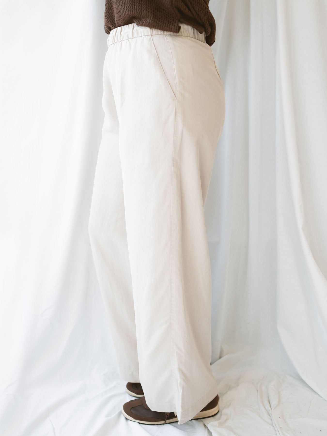 Model wearing wide leg trousers with drawstring waistband