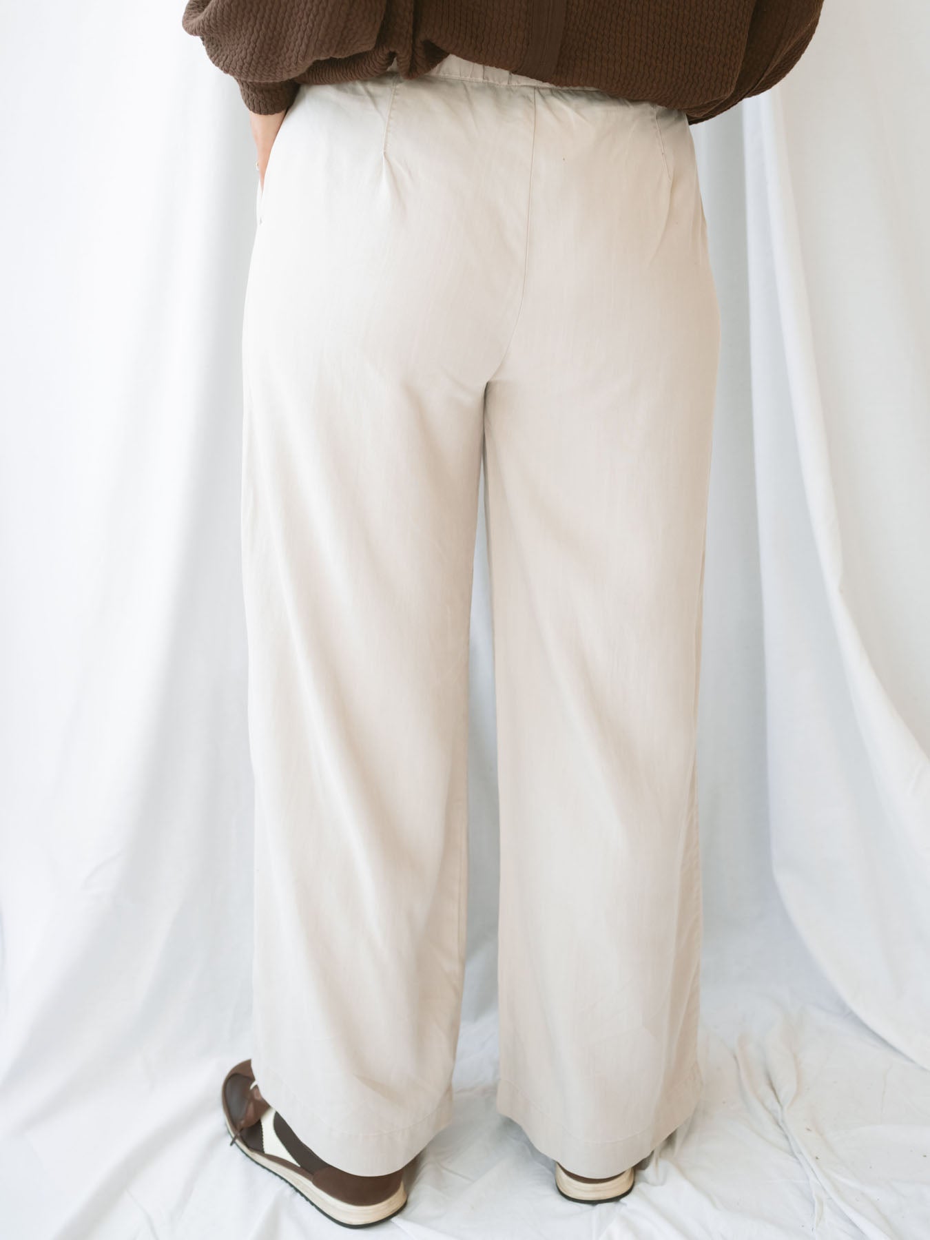 Model wearing wide leg trousers with drawstring waistband