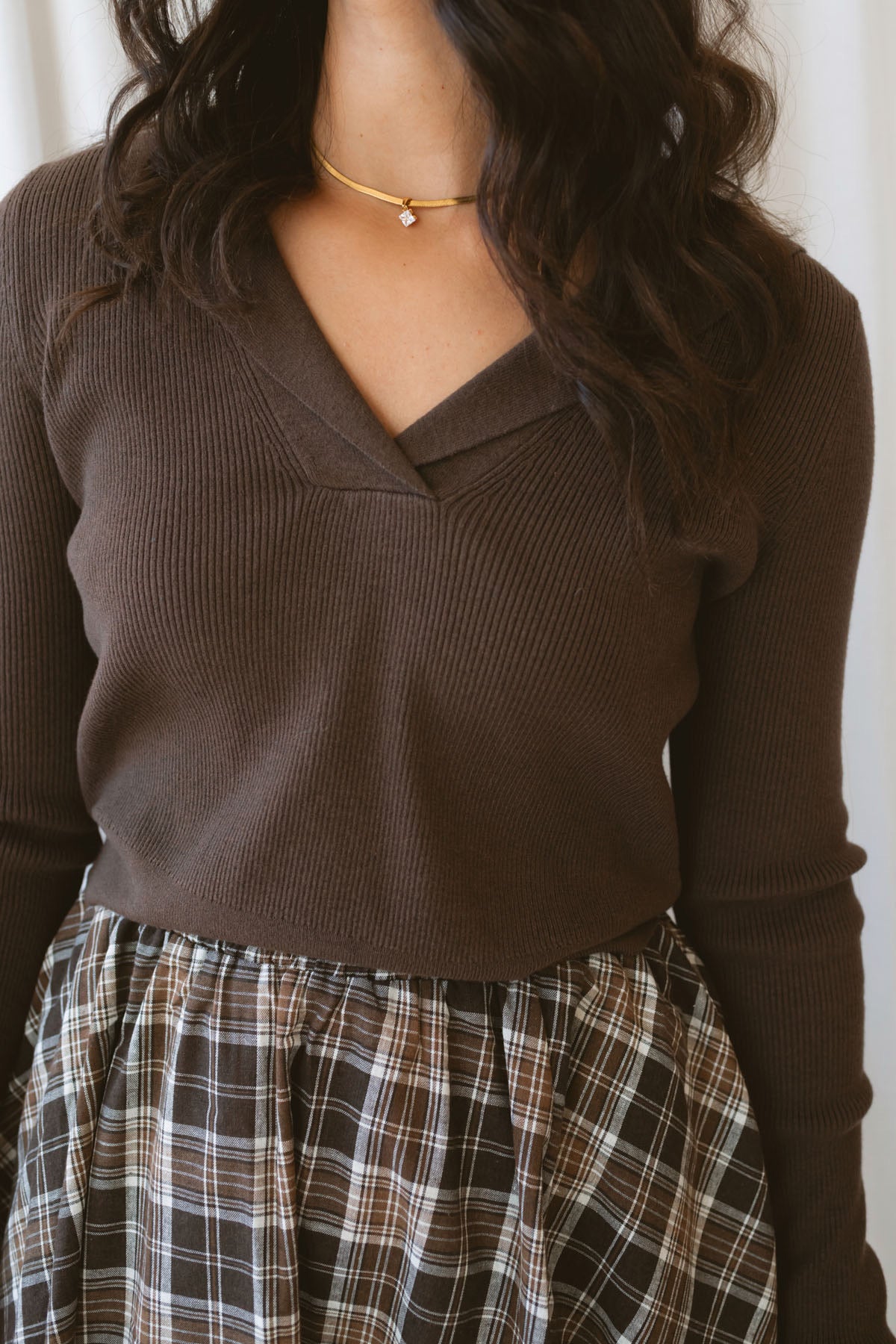 Ronny chocolate brown long sleeve ribbed knit top with an open collar neckline.