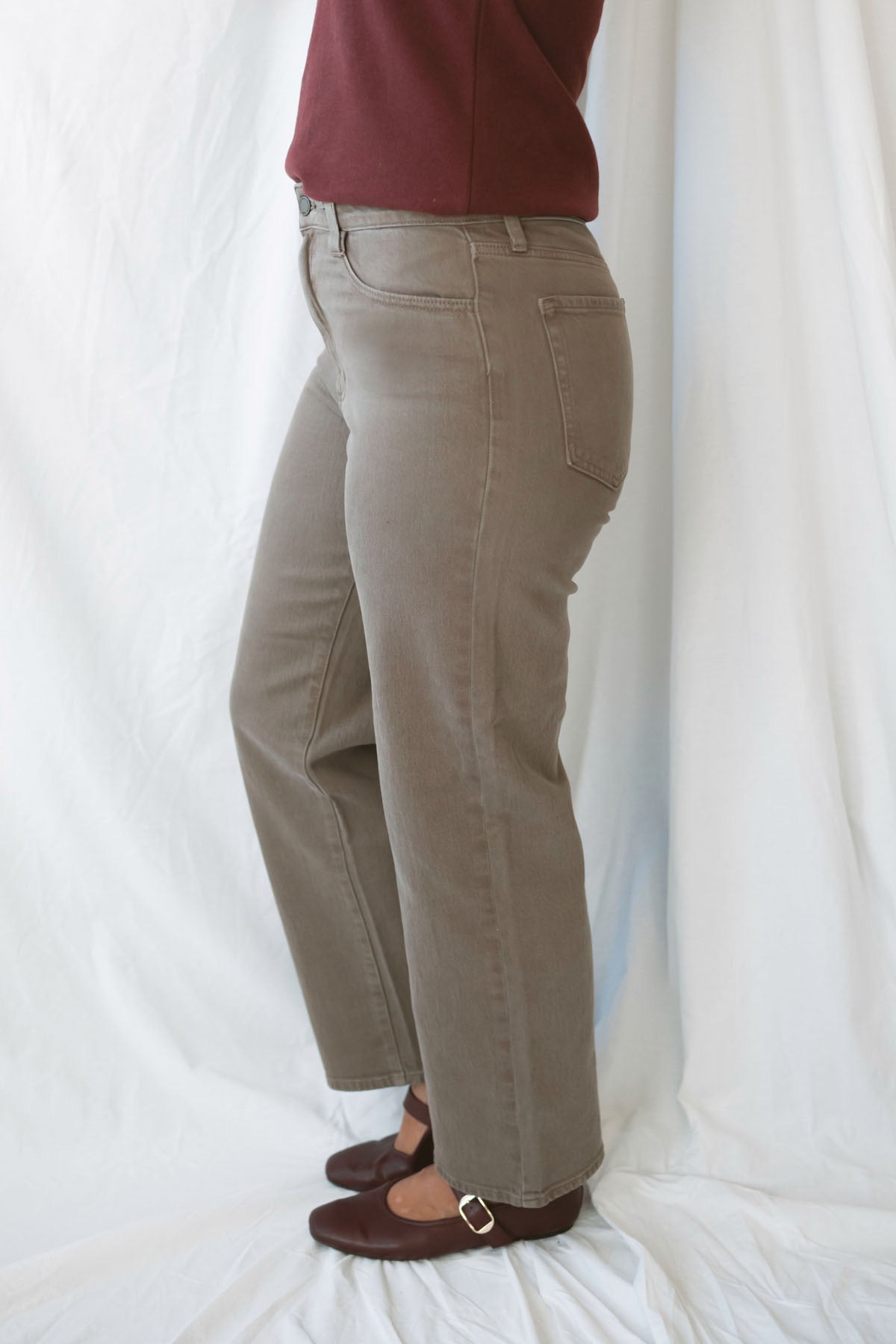 Model wearing the straight leg denim in brown.