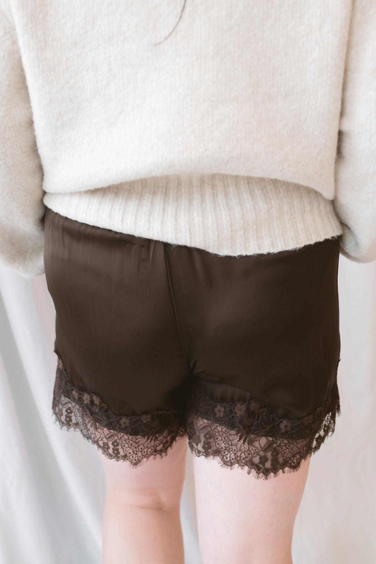 Autumn Waistband Lace Trim Hem Satin Shorts in brown with a smooth satin finish and delicate lace trim along the hem.