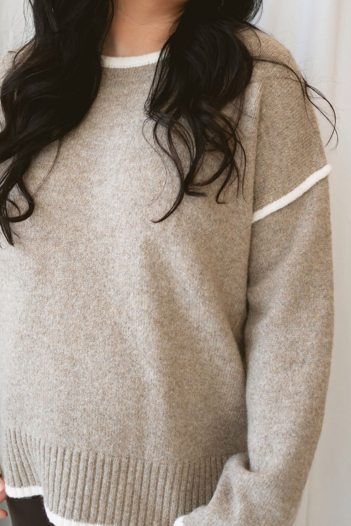 Juliana light mocha knit sweater top with long sleeves, contrast trim, and side slit hem.