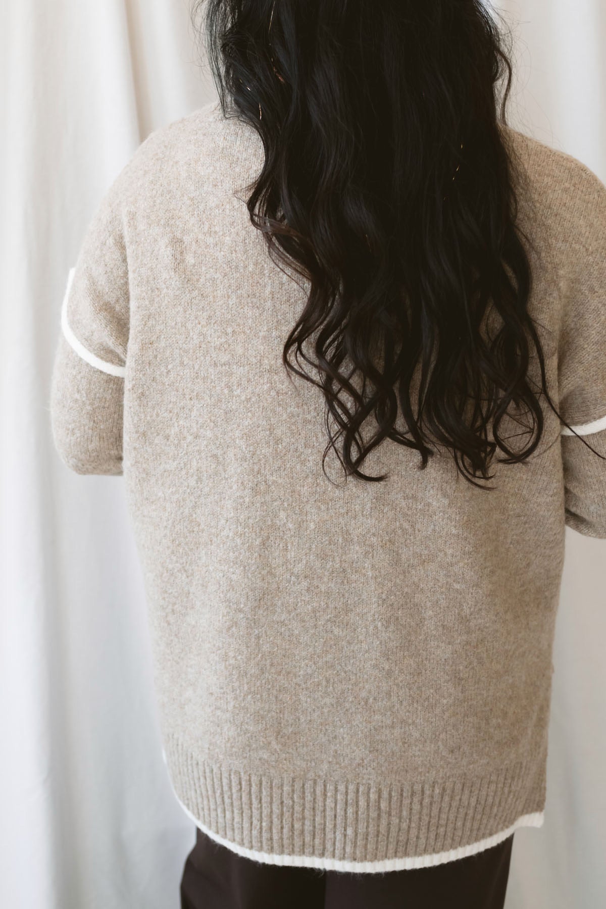 Juliana light mocha knit sweater top with long sleeves, contrast trim, and side slit hem.