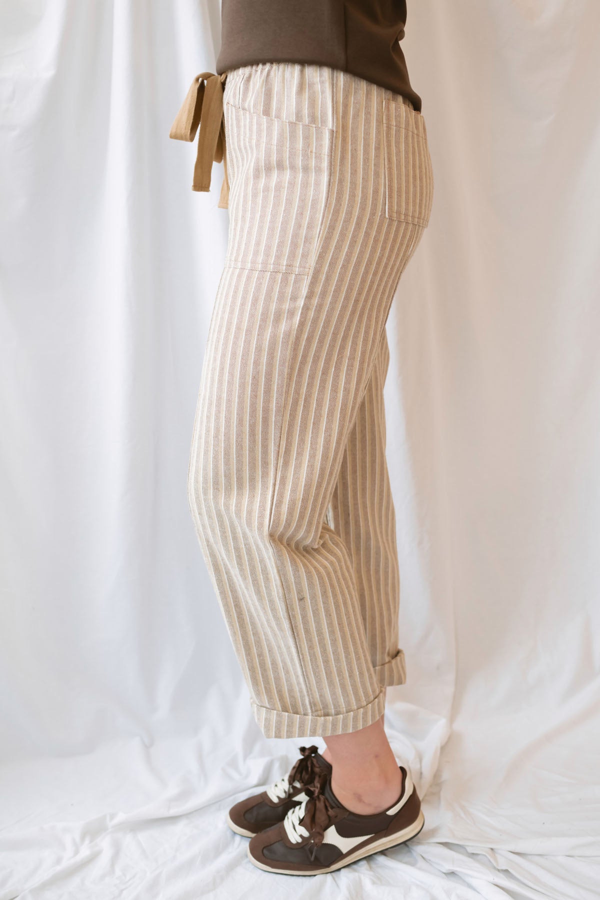 Steph Striped Wide Leg Drawstring Pants in Warm Sand Stripe featuring a relaxed silhouette and neutral striped pattern.