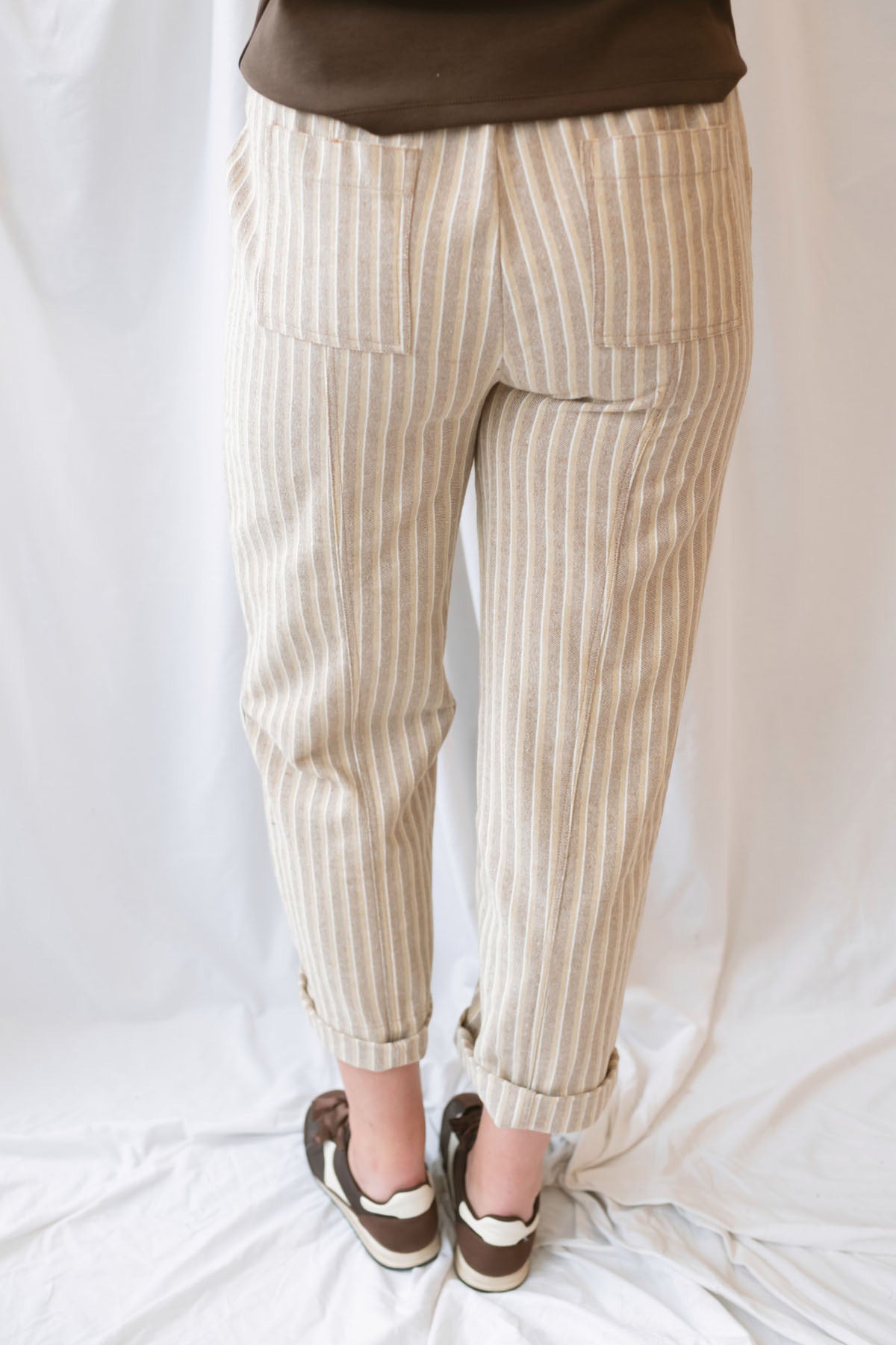 Steph Striped Wide Leg Drawstring Pants in Warm Sand Stripe featuring a relaxed silhouette and neutral striped pattern.