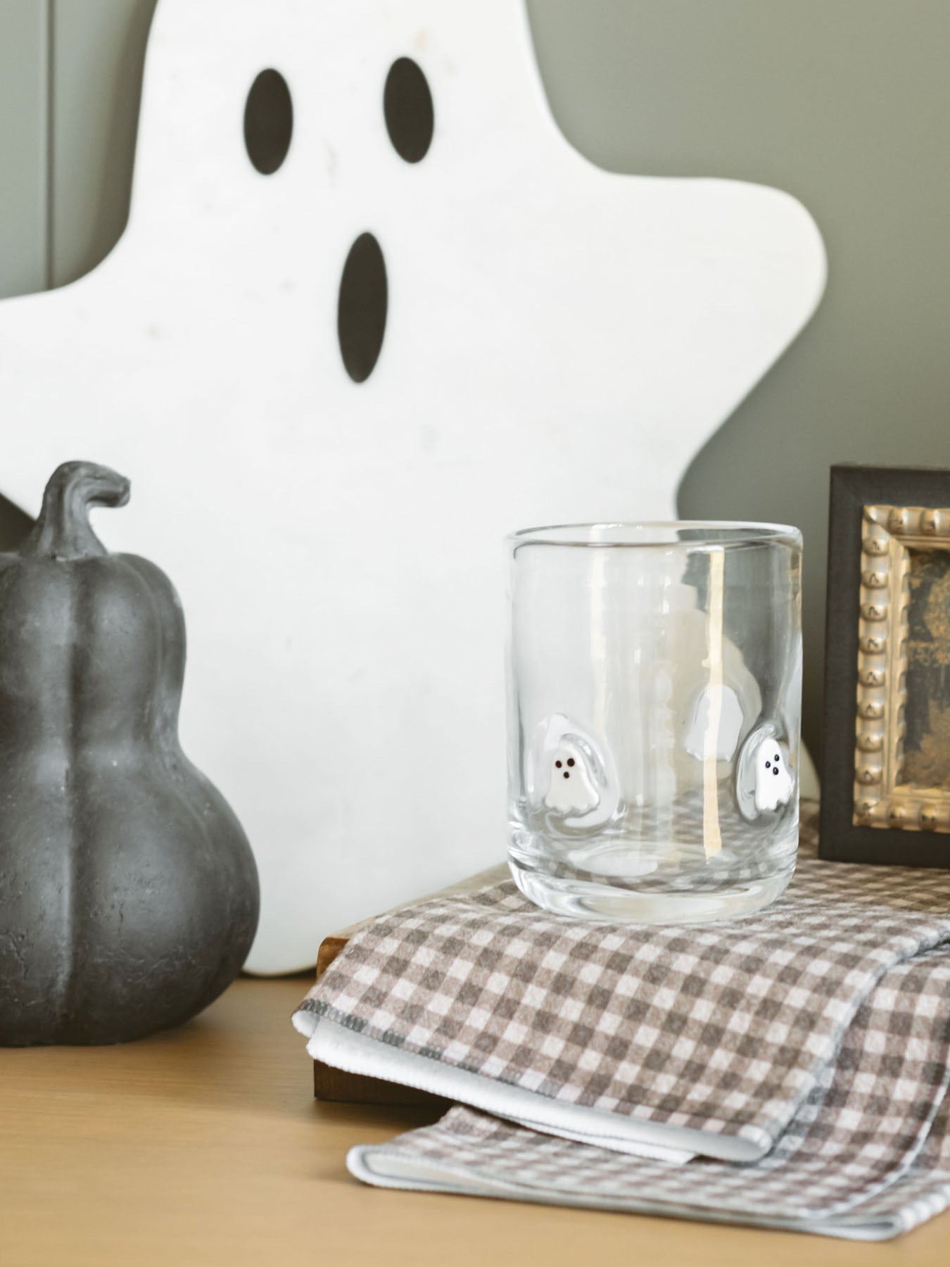 White marble ghost board set up for display as a backsplash for a drink station. Paired with black terracotta gourds for a spooky and festive setup.
