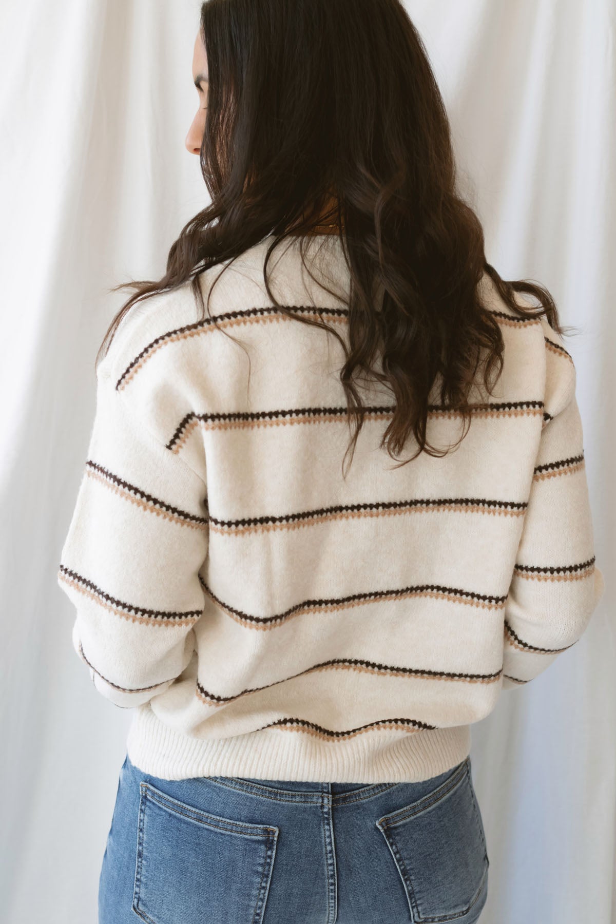 Winona oatmeal striped crew neck sweater with long sleeves and a classic knit design.
