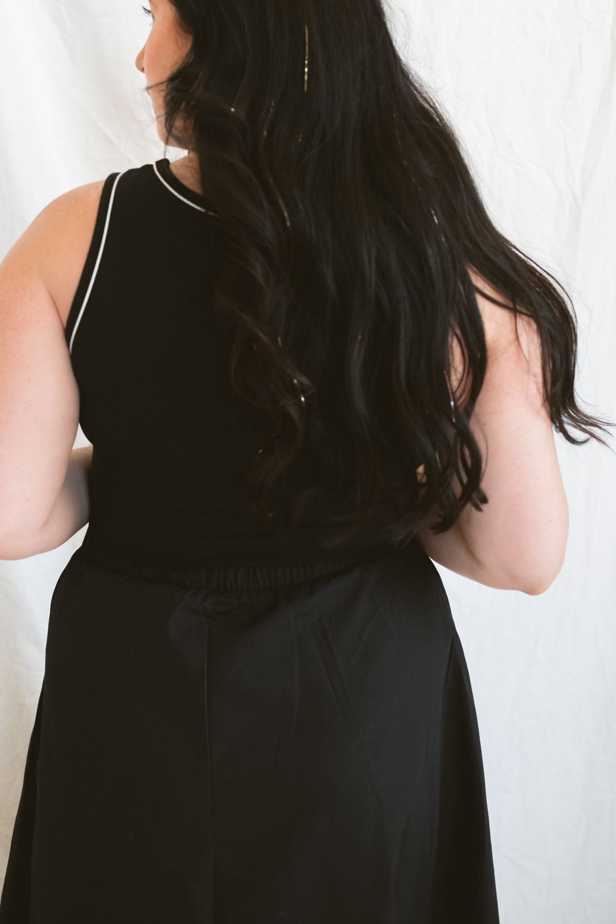 Model wearing the sleeveless piping knit contrast detail midi dress