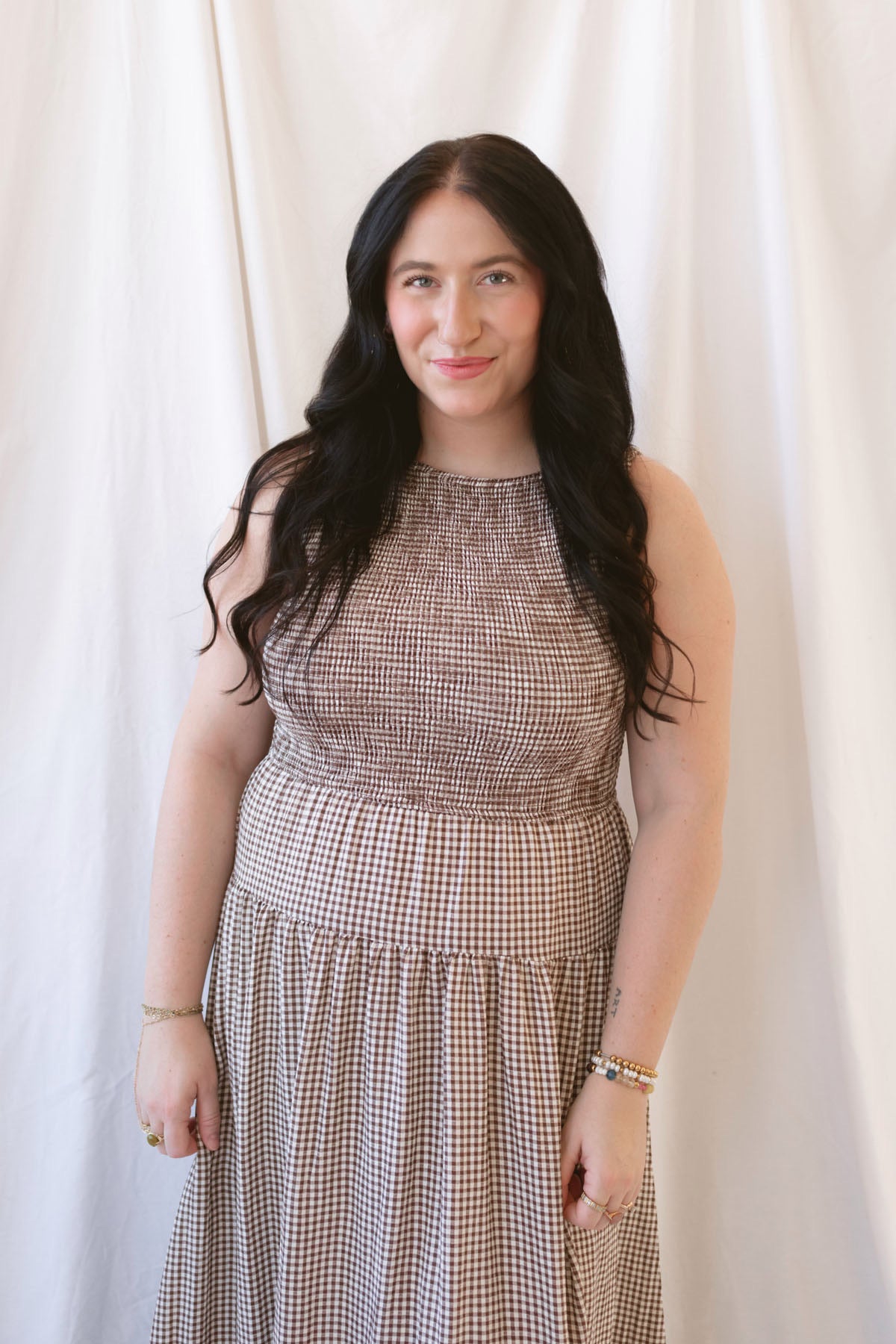 Willow brown gingham sleeveless midi dress with a smocked bodice and tiered skirt.