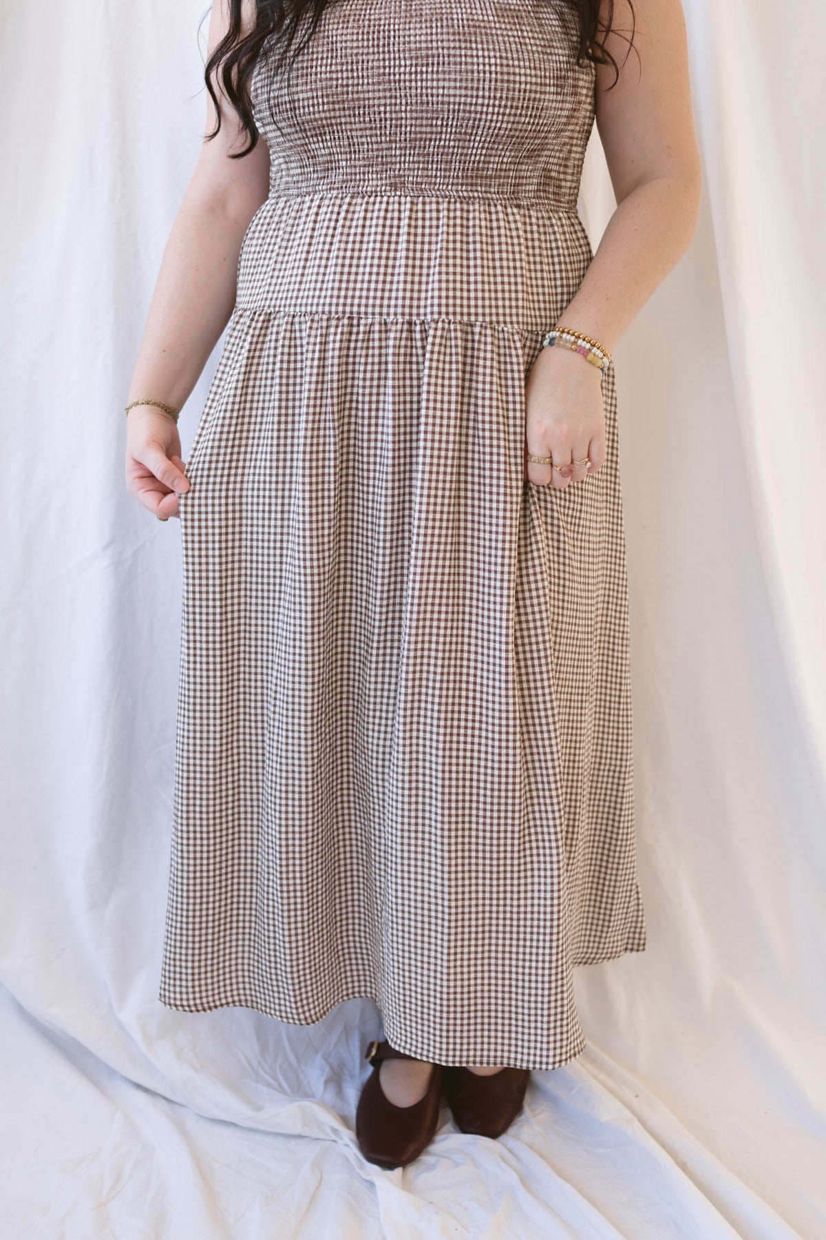 Willow brown gingham sleeveless midi dress with a smocked bodice and tiered skirt.