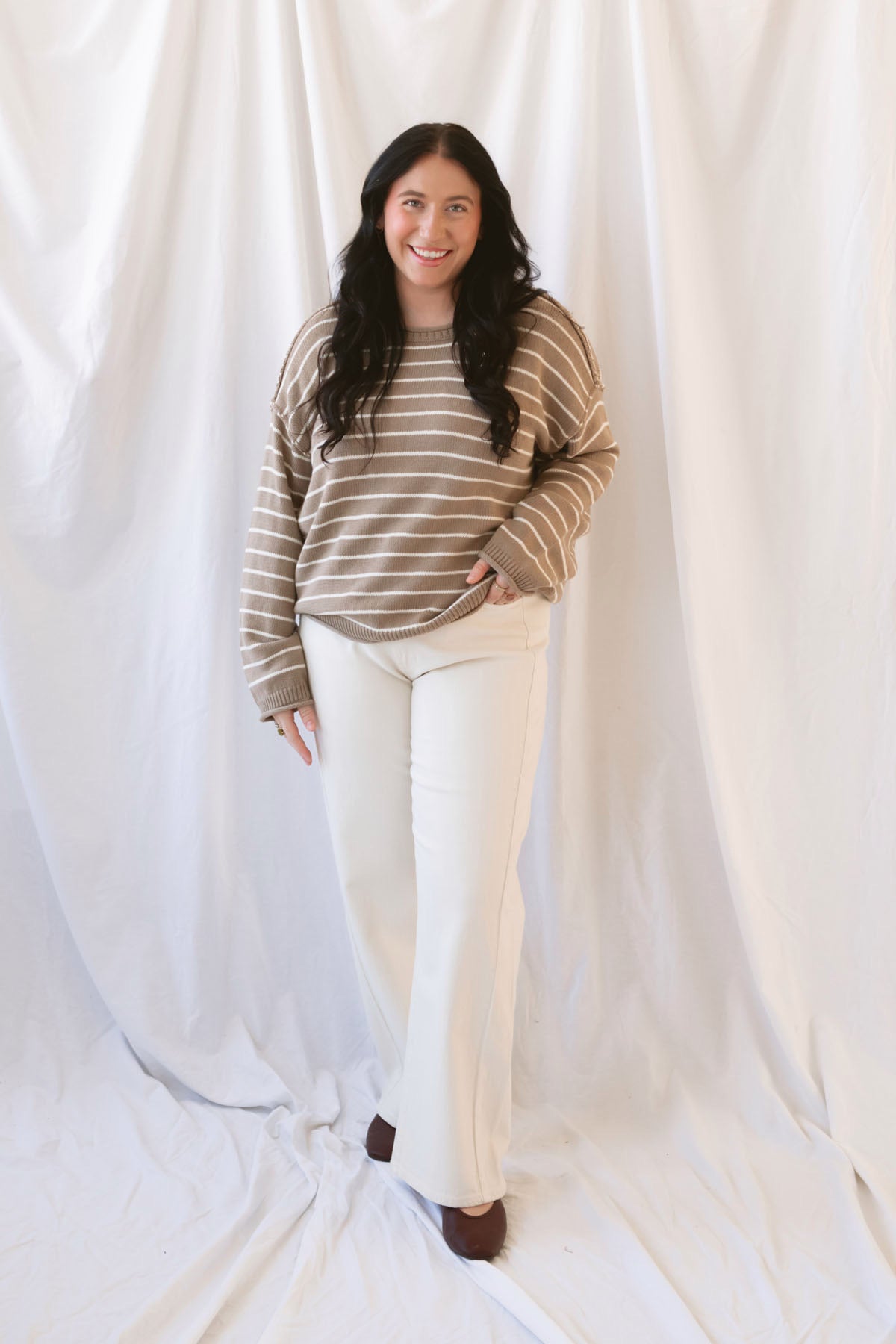 Selena taupe sweater with cream stripes, a relaxed drop shoulder fit, crew neckline, and long sleeves.