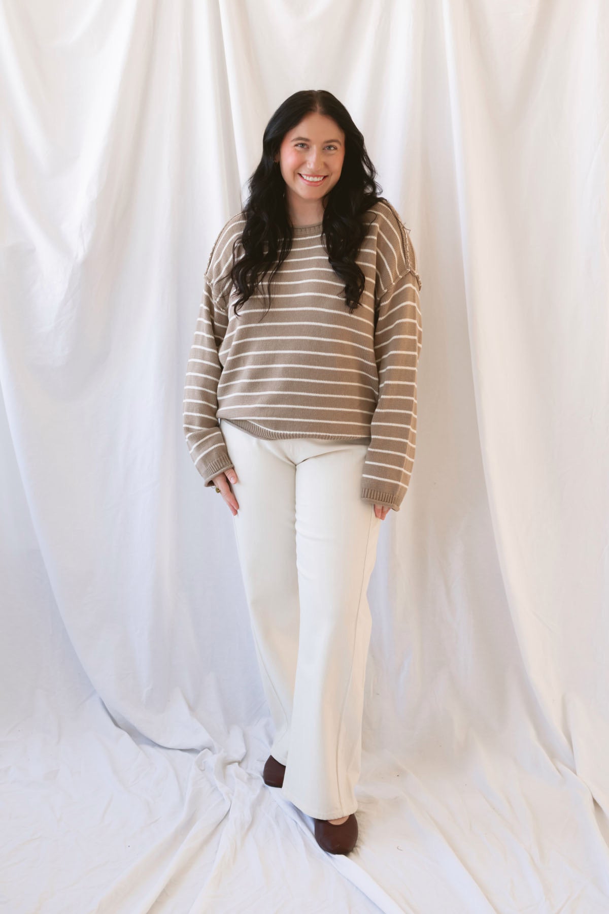 Selena taupe sweater with cream stripes, a relaxed drop shoulder fit, crew neckline, and long sleeves.