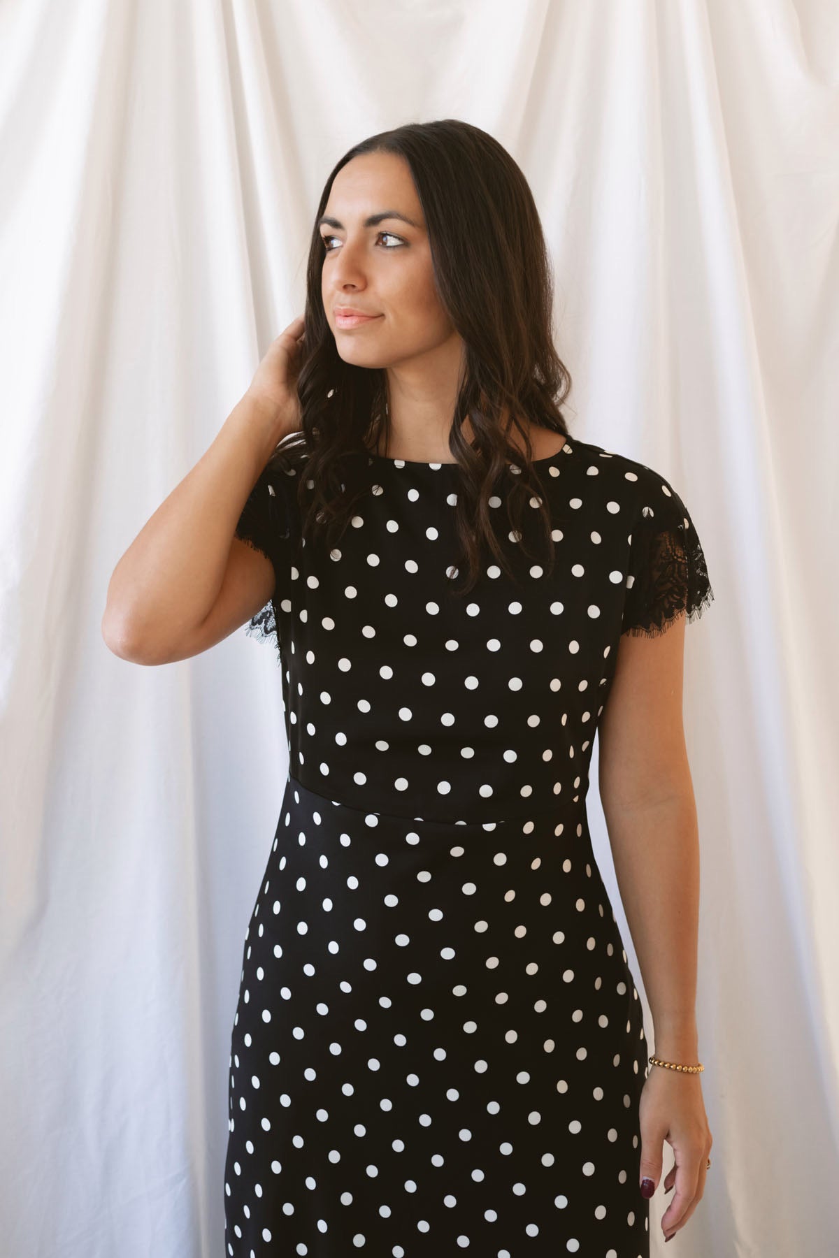 Joanna black polka dot midi dress featuring short sleeves and delicate lace trim detailing.